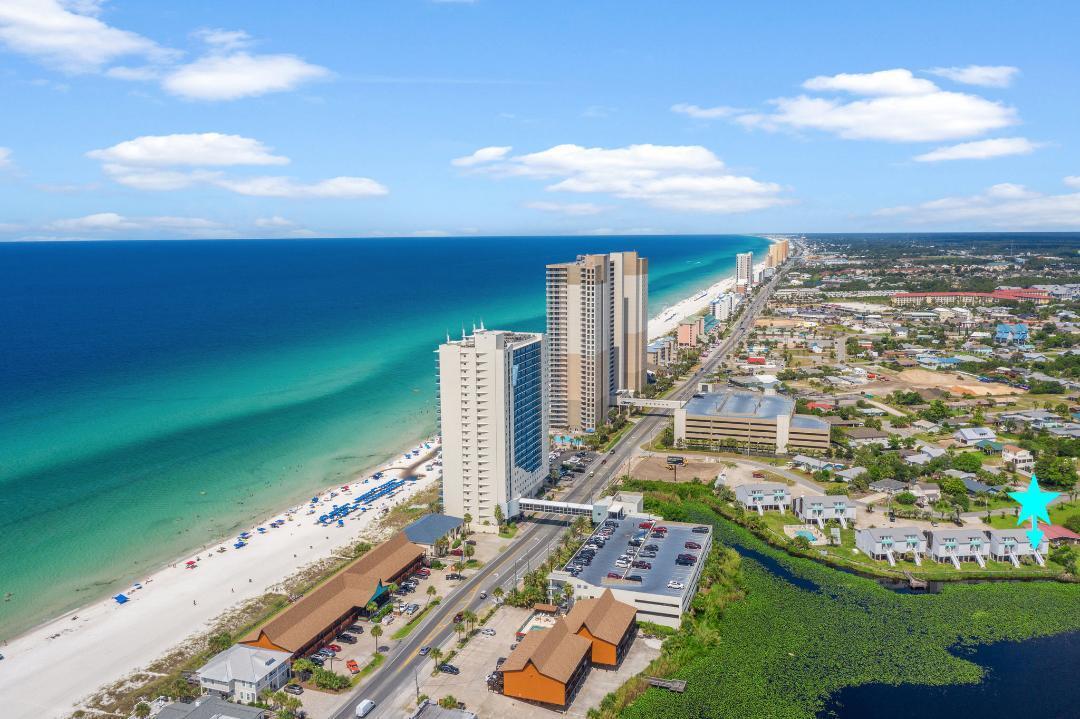 This great vacation or short term rental opportunity comes fully furnished and is turn key! You can cross Front Beach Road to the Beach and travel a half mile to Pier Park. Imagine yourself in this updated, first floor studio enjoying all of the amenities you could ask for. Just out the patio door is Lullwater Lake and within steps of the pool. The living area easily fits the full sized couch, ottoman, a 50 inch TV, and a small dining table. A king sized bed, a full length mirror, and room for a dresser fit neatly in the sleeping area. The full-sized kitchen is outfitted with stainless steel appliances. A recently renovated bathroom has a tub/shower combination and single vanity which includes a humidity sensing fan. This condo has a new HVAC, new luxury vinyl plank flooring, and a new sliding patio door. Rental income for 2023 was $29,000 and for 2022 was $33,000 in this self-managed condo. Don't miss your opportunity to purchase this gem.