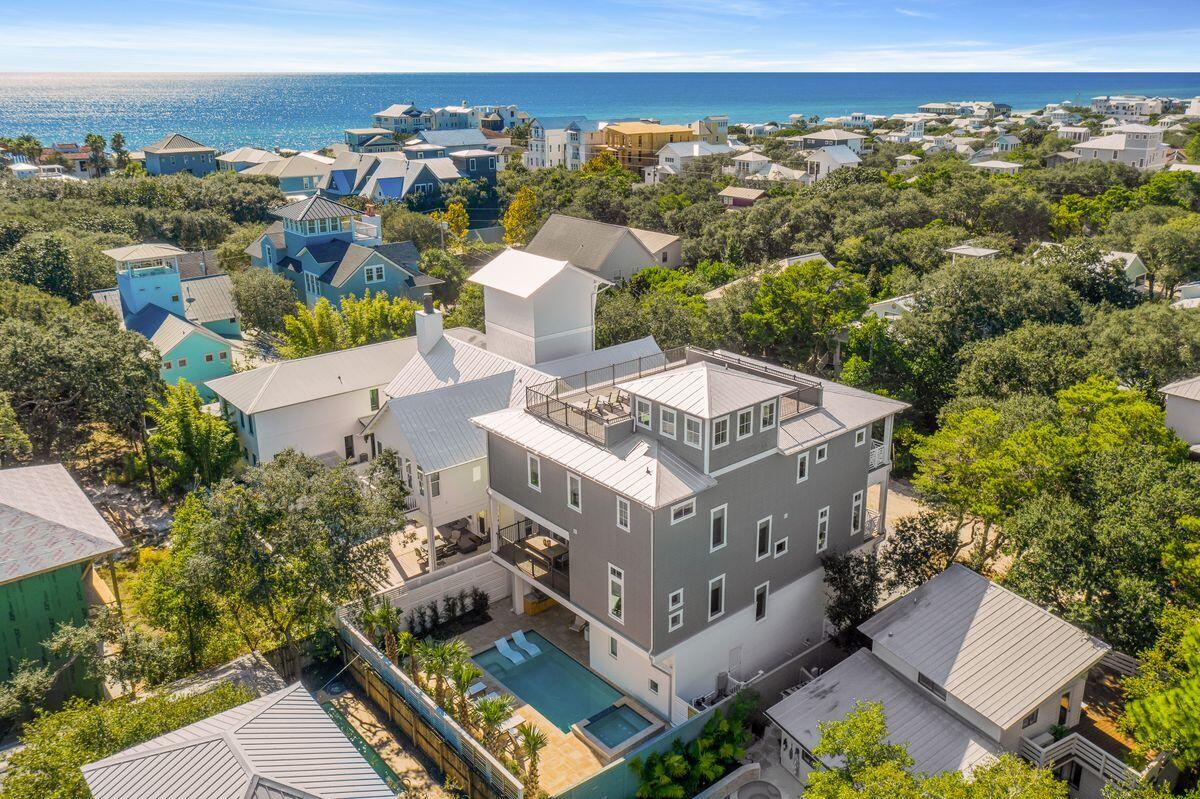 Situated in the heart of Old Seagrove, west of County Road 395, this exemplary new construction is characterized by ample open living space including a sprawling fourth story rooftop deck as well as panoramic water views with corridors of the Gulf of Mexico. Located only a few blocks from Seaside, FL, this home was recently finished and designed by Jennifer James Lyons of James Design Company and offers six bedrooms (plus two bunk spaces), eight baths and an impressive three story vertical footprint with open living space and resort style amenities including an oversized heated pool with adjoining spa surrounded by a lush, private outdoor living area.