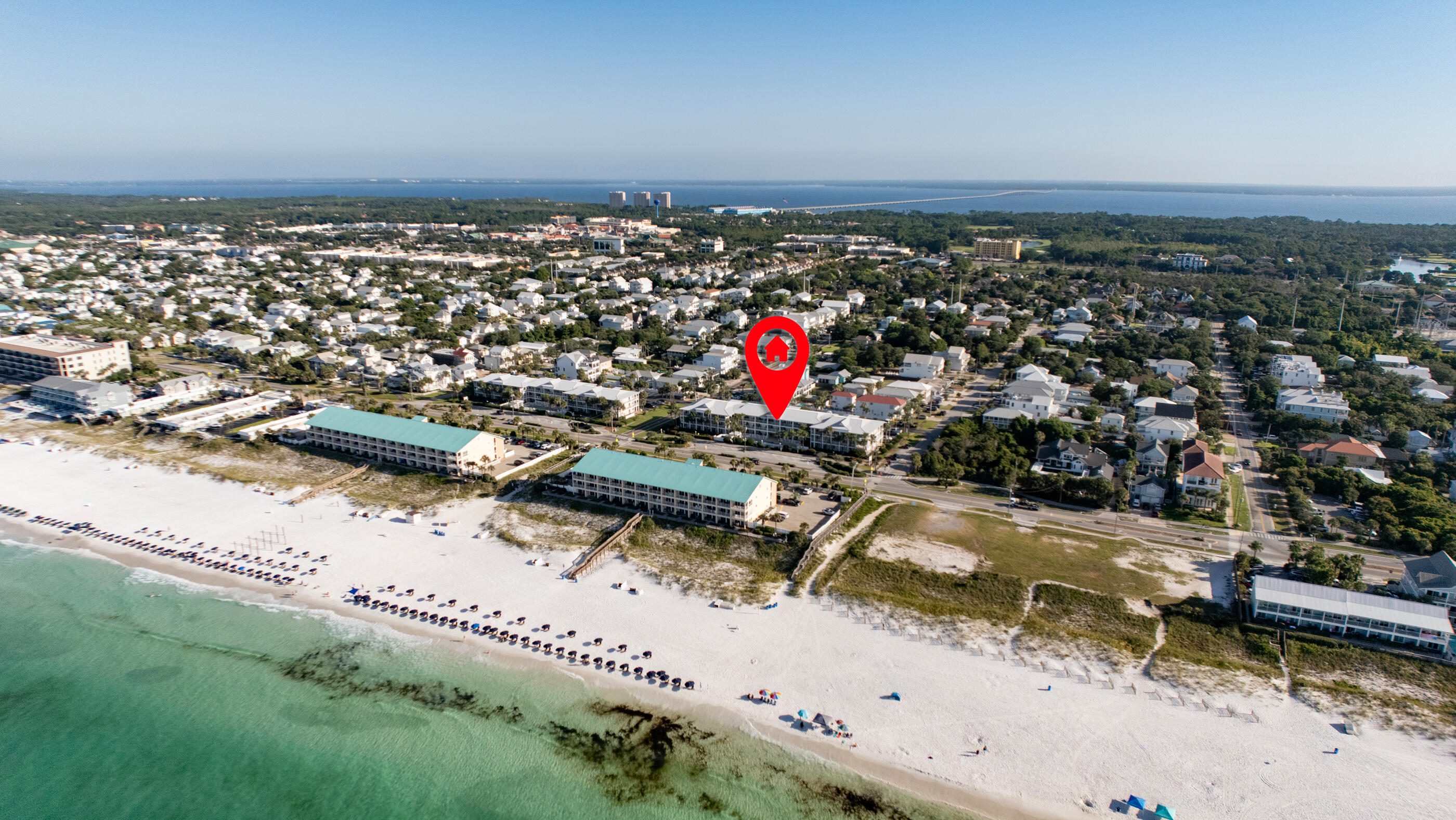 Welcome to this stunning 2 bedroom plus bunk beds condo at the Grand Caribbean in the heart of Crystal Beach. Step into a contemporary oasis boasting modern furnishings and an open layout that invites comfort and style. This tranquil condo is a corner unit which means an expansive, wrap-around patio, offering front-row seating to sunsets and the soothing sounds of waves. The owner's suite provides a serene escape with its attached private bathroom and king bed, while the second bedroom offers two queen beds and a quiet place to relax or watch tv. This unit features a stackable washer and dryer AND built-in bunk beds. With its seamless integration of indoor and outdoor living, this condo's vibe is chill. The Grand Caribbean offers a pool, hot tub and beach access right across the street. The grounds are immaculately kept and you'll even get a storage unit to store your beach goodies.