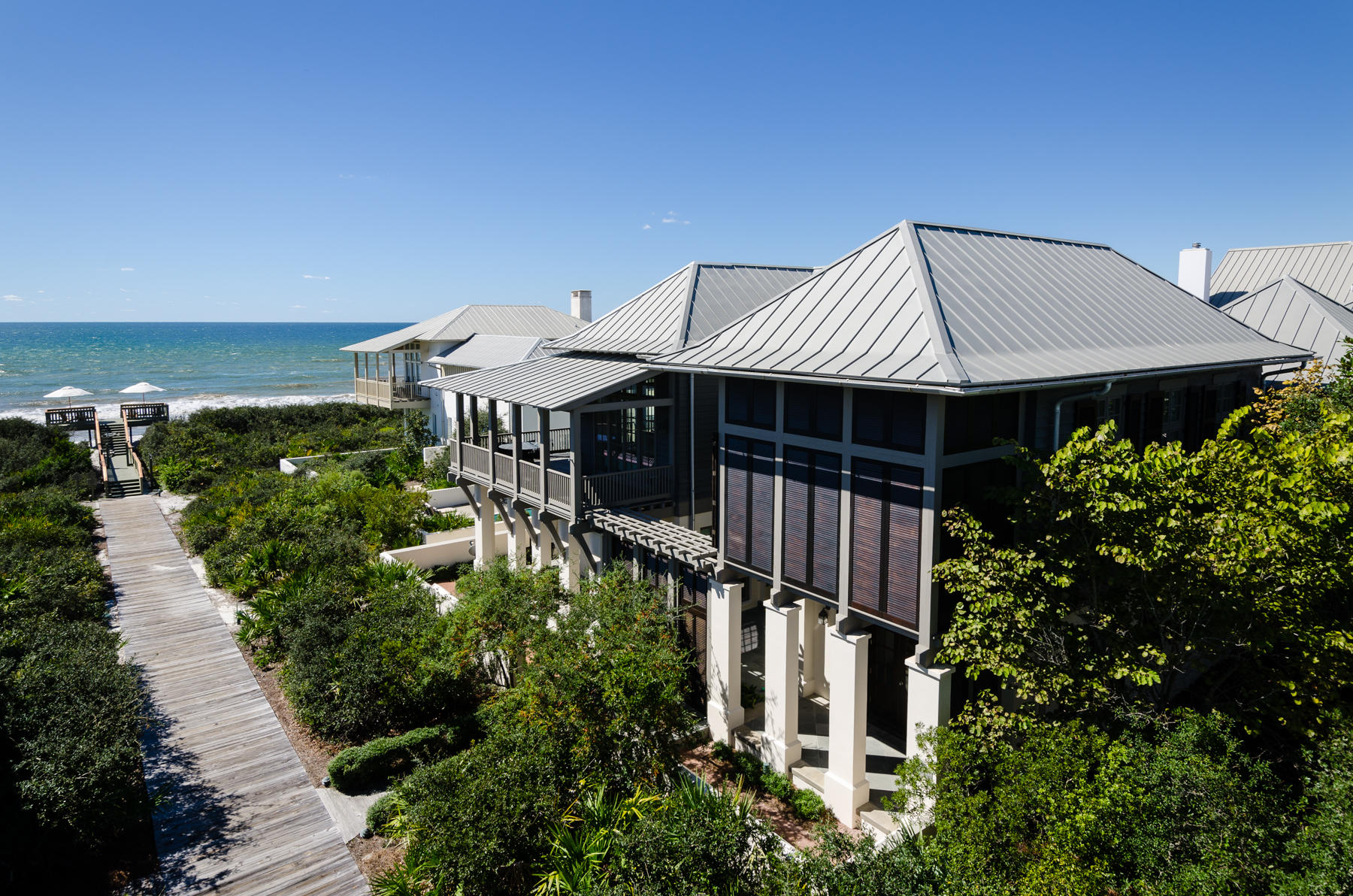 CARRIBBEAN STYLE AT ROSEMARY BEACH, this Grand Home portrays the best features of Island Living with multitude Balconies and Porches where the Panoramic Gulf Views permeate both the interior and exterior space! The expansive flow of rooms on Level 2 follow the Urban concept of the Duany Plater-Zyberk Architecture of the Town of Rosemary Beach with the primary living area overlooking the street and boardwalk to take advantage of the Views. The Living Room hosts an elegant Fireplace which may be enjoyed from the Dining Room which opens into the Kitchen. The recently renovated Kitchen now entertains a Wolf gas range plus a wall oven & microwave, Calcutta Gold marble on counters & Breakfast Island, an Asko dishwasher and ice maker. On this Level, the Master Suite relishes Gulf views