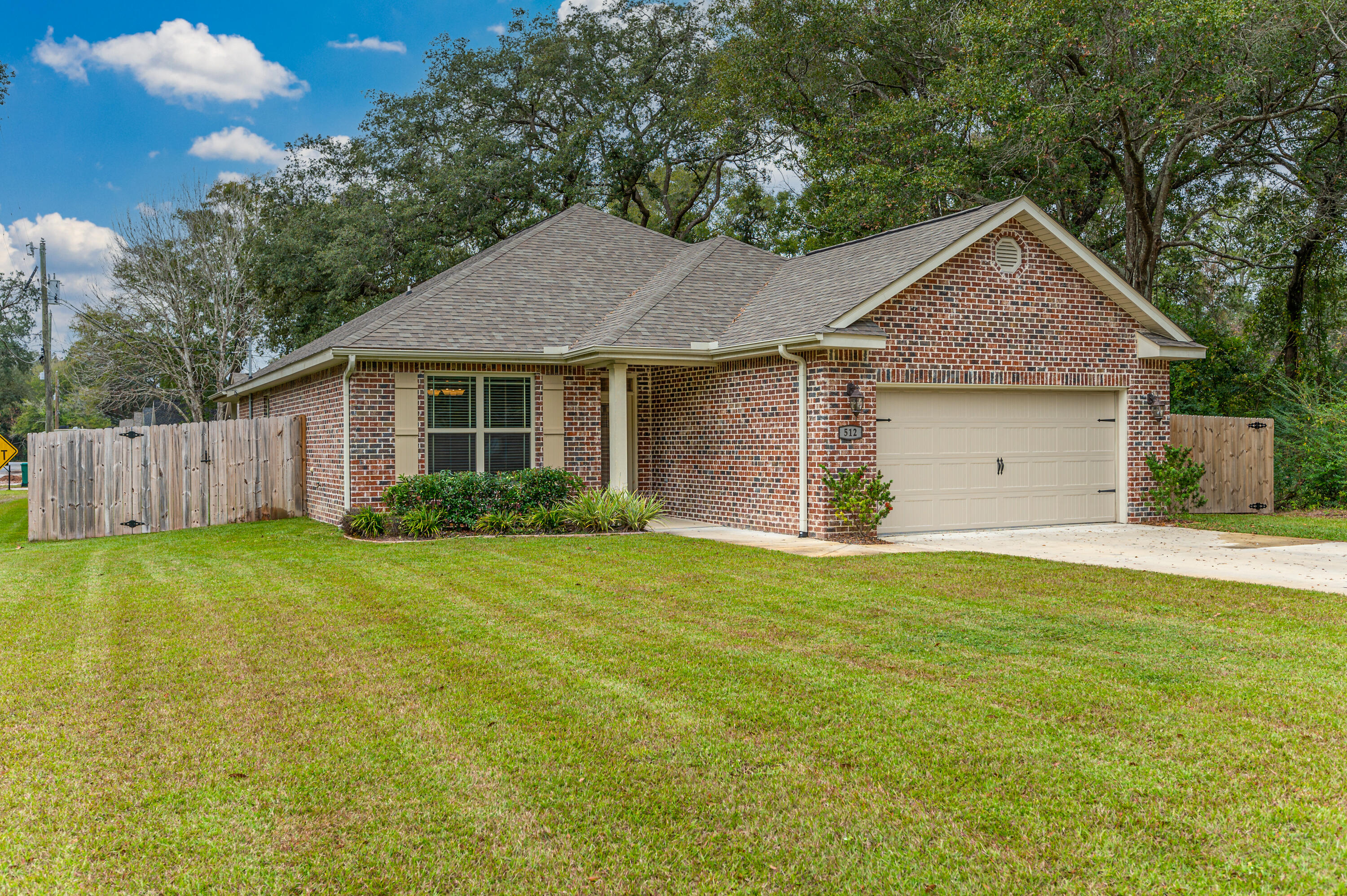 Watree built, in 2020 and ready for new owners. With 4 bedroom and 2 bathrooms, and plenty of space on the side of the yard for a boat or RV. There is a parking pad already in place. Home is located in the center of Niceville and only minutes to Eglin AFB. With the large driveway you will not be lackying for space to all your vehicles. Spacious back yard for your entertaining fun anchored by an old Majestic Oak tree. The home has a split bedroom design with an open floor plan. Kitchen offers granite countertops, tiled backsplash, stainless appliances and dark cabinets. The living area has modern tile flooring, while the bedrooms have carpet. Next to the kitchen is a formal dining room. The master bedroom includes a trayed ceiling.