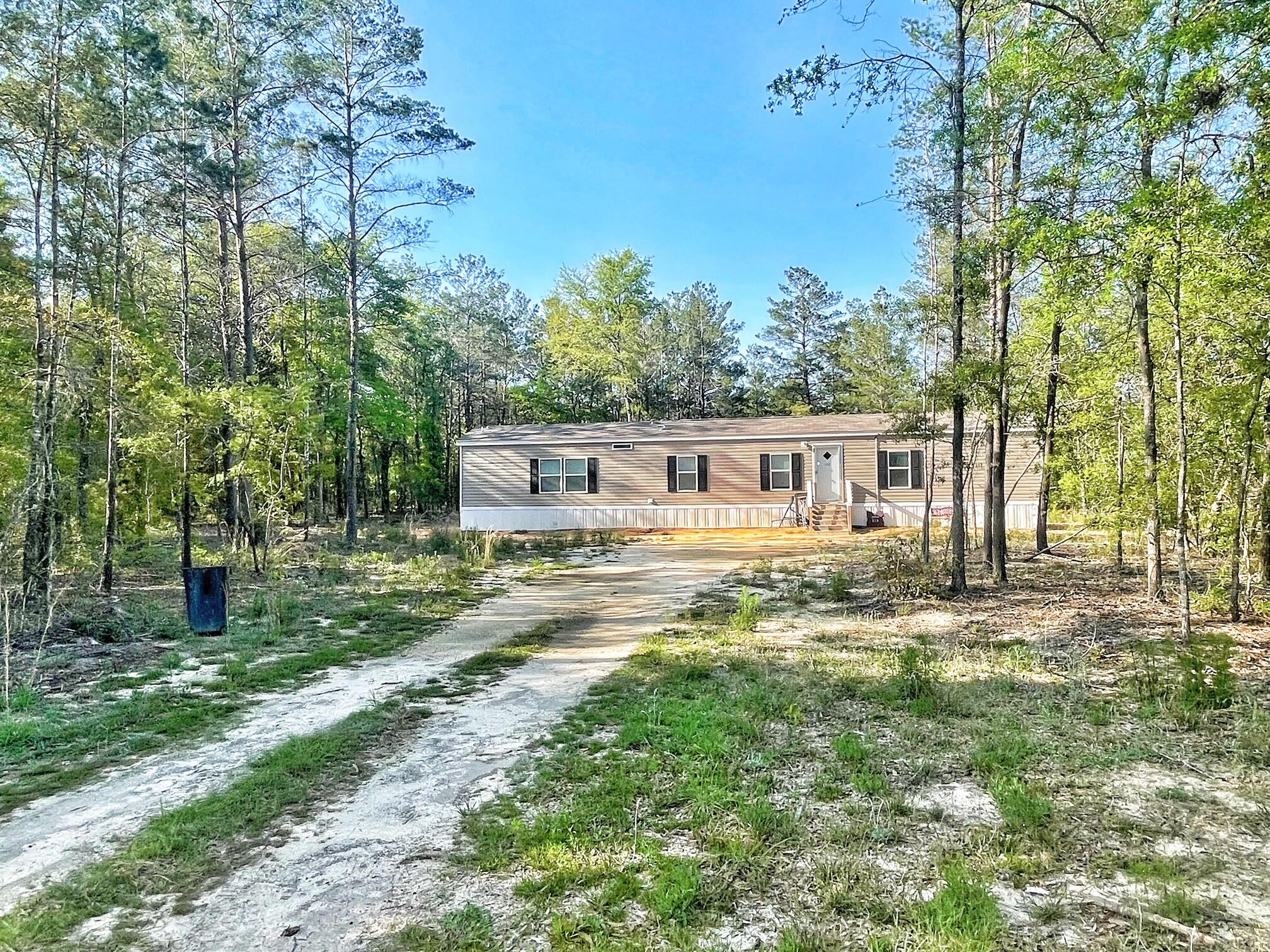 Check out this 2020 manufactured home on over 1 acre on a paved road!  This home is situated in the middle of the property giving you a large front and back yard. Half of the property is cleared and half is wooded. This home has been barely lived in and still looks new. Open kitchen and living area with shiplap accents in most of the rooms. Master bedroom is spacious with walk-in closet and bathroom with large garden tub and separate shower. All measurements should be verified by buyer. Schedule your tour today!