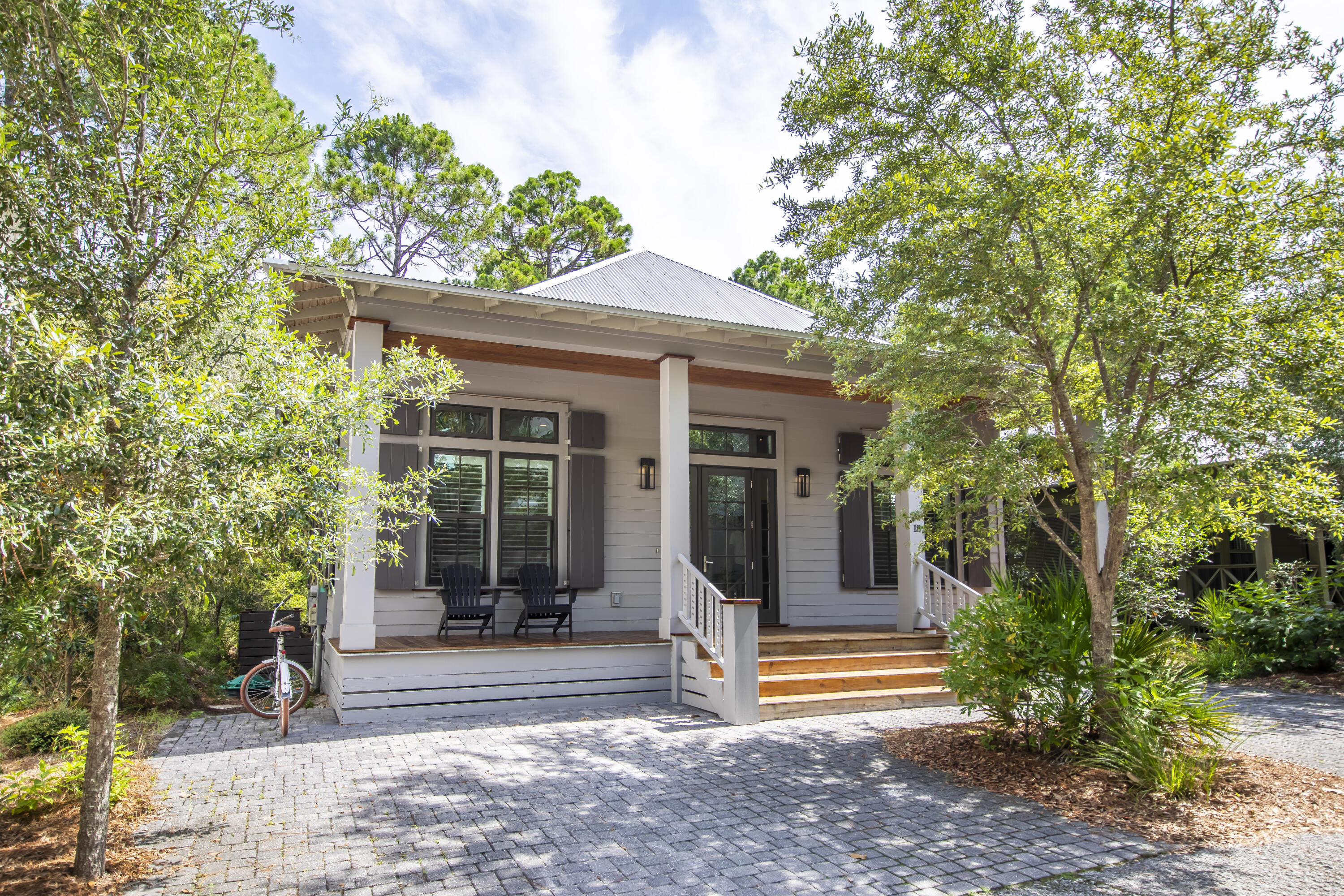 Welcome to your new coastal retreat! Nestled in a serene, gated community, this delightful 3BR, 3BA cottage offers a perfect blend of comfort, style & location. Just a short stroll to the white sands of the Gulf & moments away from vibrant shopping & dining options, this home promotes the ultimate coastal lifestyle. An inviting floor plan seamlessly connects the spacious living room, dining area & kitchen - perfect for entertaining or quiet nights at home. 12' Ceilings with large windows fill the space with natural light & provide views of lush greenery & charming neighborhood streets. Outside, a large covered porch & open deck with a conservation easement invites morning coffee & evening warm breezes - ideal for relaxing after a beautiful day at the beach. Call for a private tour today!