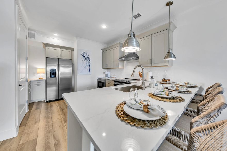 SELLER WILL PAY 2025 HOA DUES WITH ACCEPTABLE OFFER!!!BRING ALL OFFERS!!!  FURNITURE NEGOTIABLE.Welcome to Pinewoods 30A, a premier condominium located in the heart of Santa Rosa Beach. This elegant one-bedroom deluxe unit embodies coastal luxury, offering a curated blend of modern sophistication and timeless design. Professionally decorated and thoughtfully planned, this condo provides an elevated living experience, with premium features such as a fully equipped kitchen with quartz countertops and khaki cabinetry, floating shelves, gold kitchenware, and shiplap accent walls.Step into a spacious foyer that leads to an open-concept living space with 10-foot ceilings, crown molding, and large windows that flood the unit with natural light. The master retreat boasts a walk in closet, solid wood furniture, and a new PURPLE mattress, providing the ultimate in comfort. The suite bathroom is a sanctuary, featuring a deep soaking tub with floor-to-ceiling tile and brushed nickel fixtures throughout. The private balcony offers the perfect setting for enjoying serene sunrises or sunsets, with unobstructed views and ample privacy. This top-floor unit ensures peace and tranquility with soundproof walls and scenic surroundings.  Built in 2022, this unit is practically brand new and is rental-ready with the potential for excellent income whether you opt for short-term vacation rentals or long-term tenants. The attention to detail extends to custom blinds, thick curtains, and energy-efficient GE appliances, all of which convey the sale.

Pinewoods 30A is not just a home; it's a lifestyle. Residents have access to luxurious amenities including a resort-style pool, hot tub, fitness center, locker room, and future community store. With the added convenience of underground utilities, covered parking, and a low HOA fee of $509.73 per month, this condo offers exceptional value. Additionally, the property is located just two miles from the pristine white sands of the beach, close to boutique shopping, dining, and outdoor activities. Don't miss this rare opportunity to own a luxurious, yet affordable, coastal retreat in one of Santa Rosa Beach's most sought-after communities. Come experience the allure of 30A living at its finest!