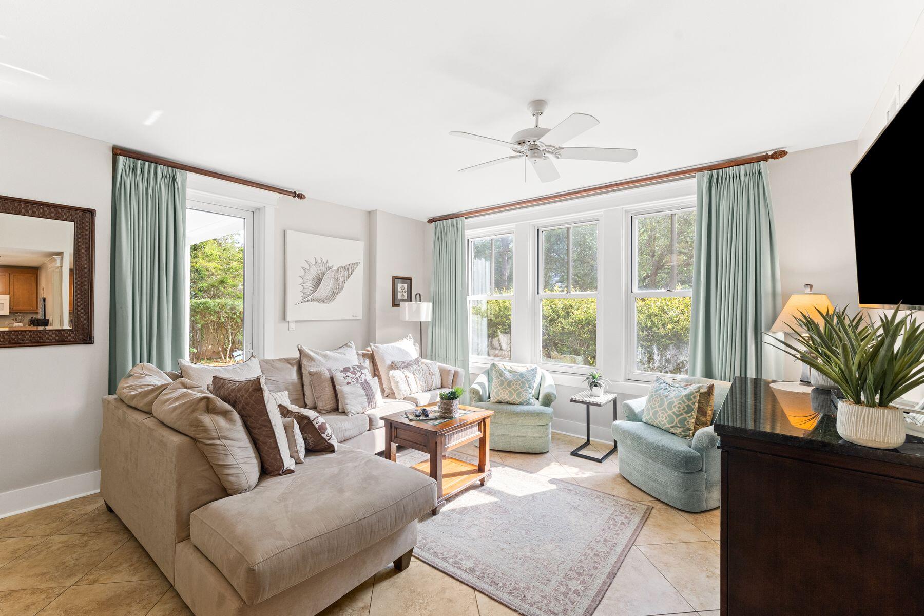 Nestled within the Grand Complex in Sandestin Golf and Beach Resort, this elegant first-floor end unit is stylishly appointed and enviably located. The light and spacious sitting room has a designated dining area for formal gatherings and family meals. Tile floors flow into the kitchen which has a peninsula bar with stools for savoring drinks and snacks. Wood cabinets and white appliances are complemented by a generous pantry. There's even a stacked washer and dryer tucked behind a closed door. Two beautiful bedrooms deliver the utmost comfort. The primary suite includes an ensuite bathroom with a twin vanity, deep soaking tub and separate shower. A glass door leads onto the private terrace for a solitary morning coffee with songbirds. There's a second bedroom with a closet and a further bathroom with a walk-in shower. The living space seamlessly flows outdoors onto an expansive covered porch that adjoins a tranquil grassy courtyard. Imagine hosting family gatherings in this lovely outdoor space or watching children and pets frolic in your own private yard. Happy days can be spent at Sandestin Golf and Beach Resort, which boasts an exceptional lifestyle with community pools, four golf courses, tennis, pickleball, bicycling, a 210-slip marina, water sports and a fitness center. A handy shuttle service connects you to the nearby beach and owners have access to the exclusive Solstice Club. Dining, shopping and live entertainment are hard to beat at the Village of Baytowne Wharf with upscale shopping and a movie theater just outside the gates. This captivating condo is well-maintained and offers a turnkey opportunity for those looking for a well-located rental-ready beach retreat.