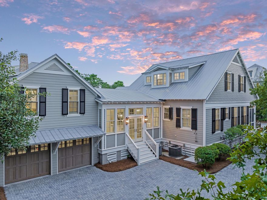 Completely and thoughtfully renovated, this exceptional five-bedroom, five-bath residence in Phase Three of WaterColor blends timeless coastal architecture with refined, modern updates. Enhanced beyond its original footprint, the home offers improved livability, beautifully refreshed interiors, and elevated finishes just steps from the Frog Pond Pool and park.Positioned on a desirable corner lot, the property features over 1000 square feet of screened porches, creating seamless indoor-outdoor living. A charming paved path leads to the welcoming front porch, an ideal setting for relaxed mornings and sunset conversations. Inside, the light-filled sitting room flows effortlessly into an elegant dining space complete with a wet bar, buffet, and built-in wine cooler. Walls of windows and French doors illuminate the hardwood flooring and highlight the home's airy, open-concept design perfectly suited for entertaining and multi-generational gatherings.

The fully renovated kitchen is both sophisticated and functional, appointed with crisp white cabinetry, quartz countertops, stainless steel appliances, generous storage, and an oversized island with bar seating. A nearby side porch provides an intimate setting for alfresco dining.

The first-floor primary suite offers comfort and convenience with a spacious, spa-inspired bath featuring dual vanities and a soaking tub. Upstairs, beneath vaulted rooflines, you'll find a charming bunk room and two well-appointed ensuite bedrooms. A second-floor screened porch overlooks the peaceful, tree-lined streetscape, an inviting retreat for coffee or a quiet read.

A separate staircase leads to the private carriage house above the two-car garage, offering a spacious guest suite with room for a king bed and twin bunks, a sleek full bath, and a cozy sitting area ideal for guests or continued rental flexibility.

Complete with an attached garage and ample parking in the paved courtyard, residents enjoy access to miles of scenic trails and boardwalks, pocket parks, resort-style pools, and the coveted amenities that define the WaterColor lifestyle.