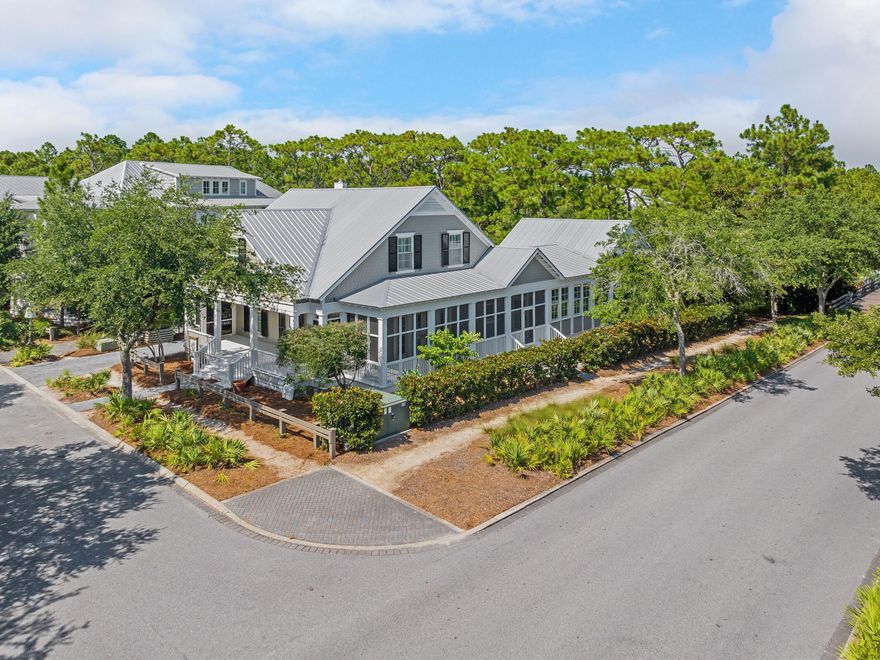 Completely and thoughtfully renovated, this exceptional five-bedroom, five-bath residence in Phase Three of WaterColor blends timeless coastal architecture with refined, modern updates. Enhanced beyond its original footprint, the home offers improved livability, beautifully refreshed interiors, and elevated finishes just steps from the Frog Pond Pool and park.Positioned on a desirable corner lot, the property features over 1000 square feet of screened porches, creating seamless indoor-outdoor living. A charming paved path leads to the welcoming front porch, an ideal setting for relaxed mornings and sunset conversations. Inside, the light-filled sitting room flows effortlessly into an elegant dining space complete with a wet bar, buffet, and built-in wine cooler. Walls of windows and French doors illuminate the hardwood flooring and highlight the home's airy, open-concept design perfectly suited for entertaining and multi-generational gatherings.

The fully renovated kitchen is both sophisticated and functional, appointed with crisp white cabinetry, quartz countertops, stainless steel appliances, generous storage, and an oversized island with bar seating. A nearby side porch provides an intimate setting for alfresco dining.

The first-floor primary suite offers comfort and convenience with a spacious, spa-inspired bath featuring dual vanities and a soaking tub. Upstairs, beneath vaulted rooflines, you'll find a charming bunk room and two well-appointed ensuite bedrooms. A second-floor screened porch overlooks the peaceful, tree-lined streetscape, an inviting retreat for coffee or a quiet read.

A separate staircase leads to the private carriage house above the two-car garage, offering a spacious guest suite with room for a king bed and twin bunks, a sleek full bath, and a cozy sitting area ideal for guests or continued rental flexibility.

Complete with an attached garage and ample parking in the paved courtyard, residents enjoy access to miles of scenic trails and boardwalks, pocket parks, resort-style pools, and the coveted amenities that define the WaterColor lifestyle.