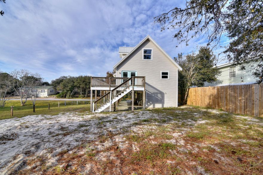 Price adjustment. Within 1/2 mile to the World's Most Beautiful Beaches! This beautifully beachy decorated 3 bedroom 2 bath home has recently been upgraded with a brand new kitchen and new bathrooms. First floor contains the Master bedroom and Master Bath while the second floor includes a split floor plan. Enjoy reading a book while lounging on the deck that wraps around the entire front of the house or cool off under the covered patio downstairs. This would make a wonderful primary or secondary home. Don't let this opportunity pass you by!