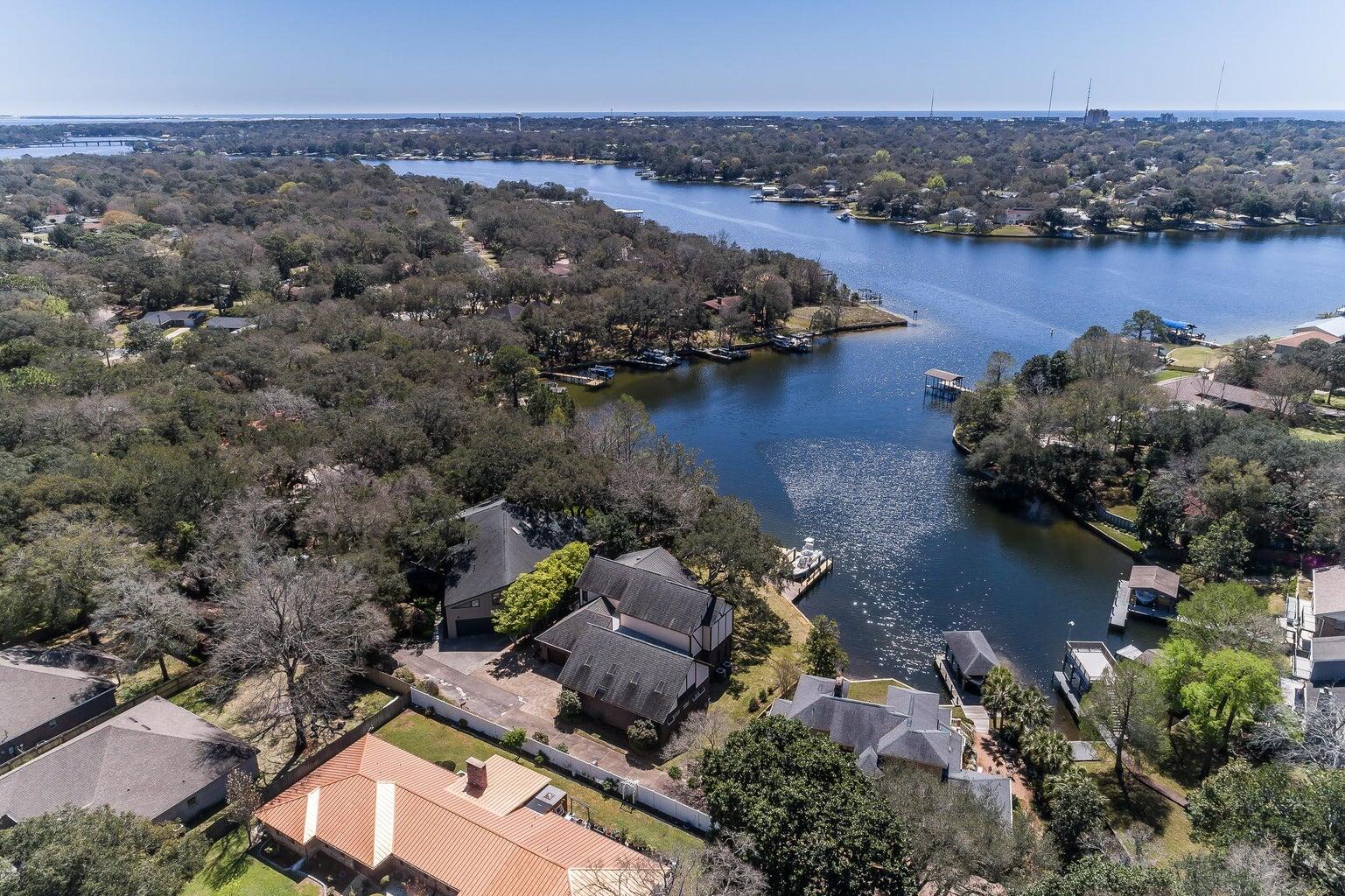 EXQUISITE Custom Tudor-Style Protected Waterfront Home with Stunning Views. X Flood Zone!! Roof 2023, Kohler Generator 2023. Welcome to your Dream Home nestled on a private, tree-lined drive in a tranquil, protected bayou. This exquisite 3-bedroom 3.5 bathroom residence offers a perfect blend of Elegance, Comfort, and Breathtaking Natural Beauty. Step inside to discover spacious living areas bathed in natural light from large windows that provide stunning views of the water. Expansive living room is perfect for both relaxing and entertaining. The master suite serves as a private retreat, complete with an en-suite bathroom and a generous walk-in closet. Each additional bedroom is equally inviting, with natural light and serene views, and the bathrooms are thoughtfully designed. And a POOL! Outdoors, the property truly shines. Enjoy direct access to the dock and boat lift, perfect for boating enthusiasts. An outdoor deck offers a stunning spot to entertain guests or simply unwind while taking in the picturesque scenery. For year-round enjoyment, the home features a heated indoor pool, ensuring you can swim no matter the season. A charming Florida room provides panoramic views of the bayou, making it an ideal spot for morning coffee or evening relaxation. The home's classic Tudor architecture exudes timeless elegance and character, while the tree-lined private drive ensures privacy and a sense of seclusion. Situated in a protected bayou, this home combines the best of waterfront living with the peace and quiet of a natural setting. This extraordinary home is more than just a residence; it's a lifestyle. Whether you enjoy boating, swimming, or simply relaxing by the water, this property offers everything you need to live your best life. Don't miss the opportunity to own this one-of-a-kind waterfront gem. Contact us today to schedule a private showing and experience the beauty and elegance of this Tudor-style masterpiece for yourself. Kohler generator added 2023.Buyer to verify all measurements.
