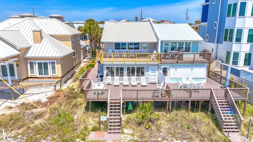 Don't miss your opportunity to own this rare single family beachfront property. Situated directly on the Gulf of Mexico! No HOA, no elevators and no offsite parking garages. This stunning 4-bedroom, 3-bathroom home offers breathtaking views and tranquil gulf breezes. With its spacious layout this property is perfect for entertaining family and friends but intimate enough for a getaway for one or two couples. Just 5 minutes from Scenic Hwy 30A's dining and entertainment. And only 10 minutes from Pier Park and its shopping, dining and clubs. Publix and Winn Dixie are less than 1 mile away.  So, you can stock up upon arrival and never have to leave your beachfront oasis.  (SEE MORE)BUYER TO VERIFY ALL IMPORTANT INFORMATION The home boasts a main living area with an open floor plan. Nine-foot ceilings and an abundance of new windows allow natural light to flood the space. Enjoy seamless transitions from kitchen and dining areas to the living room and sunporch. This continues to the outdoor living space of the expansive deck that provides the perfect spot for al fresco dining, sunbathing, or watching the sunset over the emerald waters of the gulf.
The kitchen features granite countertops, stainless steel appliances, bar seating and ample cabinet space. Whether you are hosting a dinner party or preparing a family meal, this kitchen is fully stocked and ready. The open kitchen design with elevated bar lends to the area being a common gathering place to socialize. 
Thoughtful planning made sure there was a large king bedroom with ensuite bath on the first floor.  The second floor has 3 bedrooms and 2 full bathrooms.  One king room and two bedrooms containing 2 queen beds each. The south bedroom, with its 12 feet of widows and unobstructed gulf view, opens to a 275 sf deck on which to enjoy morning coffee or sunset wine and cocktails. 
Outside amenities include two showers. One is private with hot and cold water.  A favorite of everyone who visits!  Stationary Charcoal Grill. There is plenty of parking and a lock out storage room off the carport. The deck and balcony are low maintenance composite lumber. 
The home also features new high impact window, Porcelain floors, and Stainless Steel appliances. Full HVAC replacements in 2018 of both units. Water heater 2019. Roof 2015. 
Make an appointment now to view your forever beach oasis or short-term rental investment property! Offered fully furnished with a strong rental history and future booking of new and repeat visitors. 
BUYERS ARE TO VERIFY ALL IMPORTANT DETAILS