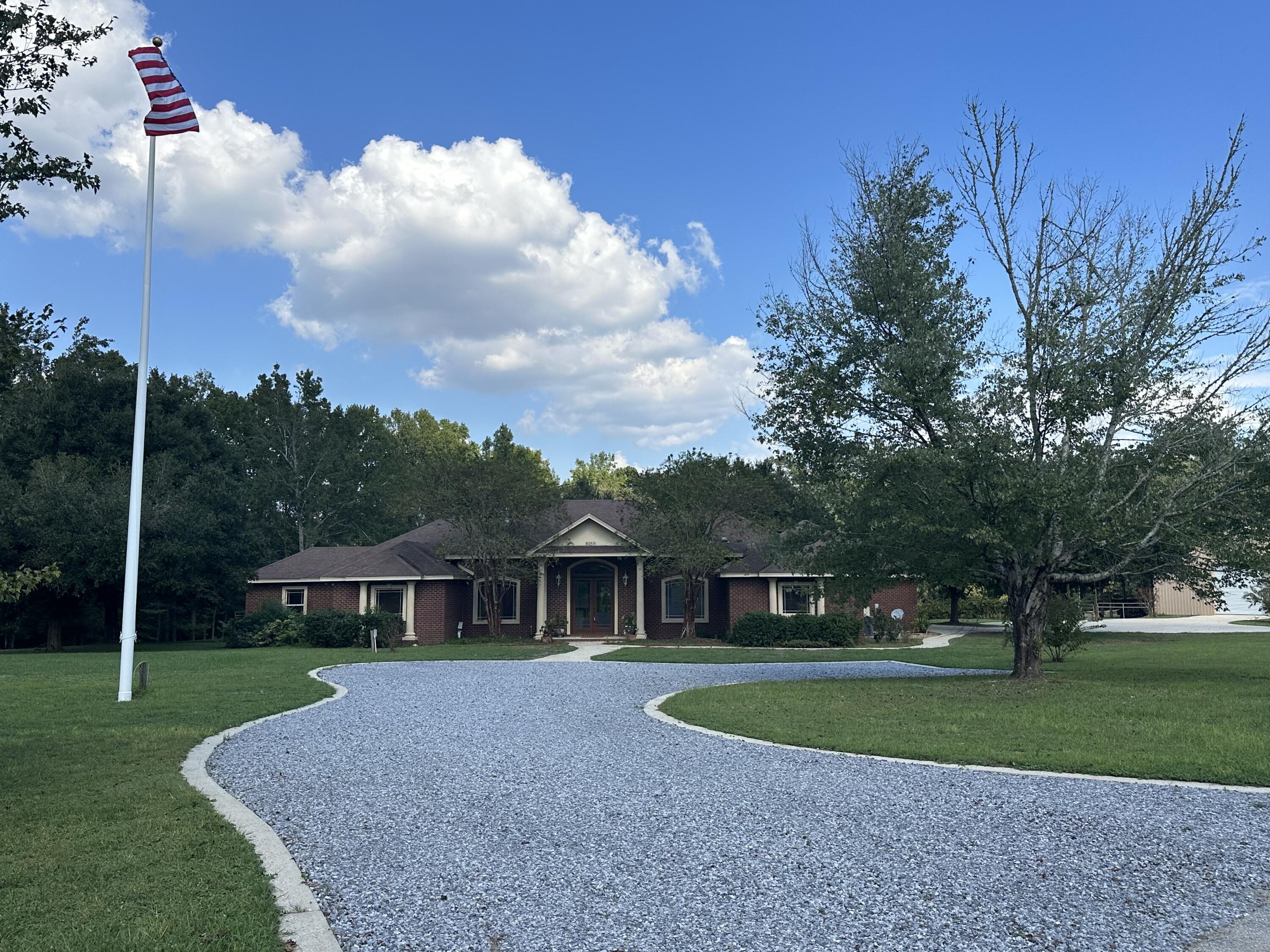 8188 Millers Street is a beautiful Custom Brick home built in 2006 on 5.03 ac. +/-. With 2771 Sf in the main house. The main house has three bedrooms, three bathrooms, a bonus/exercise room, an office, a screened-in back patio with a screen-enclosed pool, a barn with an in-law suite, with a full kitchen, two additional bathrooms, and so much more. This home was custom-built by a local contractor as a primary residence. The home boasts a grand foyer, hardwood and tile floors with custom designs. The double tray high ceilings, rotunda style accents and chefs kitchen are amazing. If you enjoy fishing, store your boat by the barn (or in it) and take your catch to the fish cleaning table with a double sink after the trip. You can store your 4-wheelers, side by side, and tractor in the barn or beside it under the additional carport, or the lean-to. 

Walk around outside to see the Martin birdhouses, lemon trees, pecan trees, figs, scuppernong grapes, and many other plants and trees growing there.
Schedule a tour of this stunning executive-style home today!