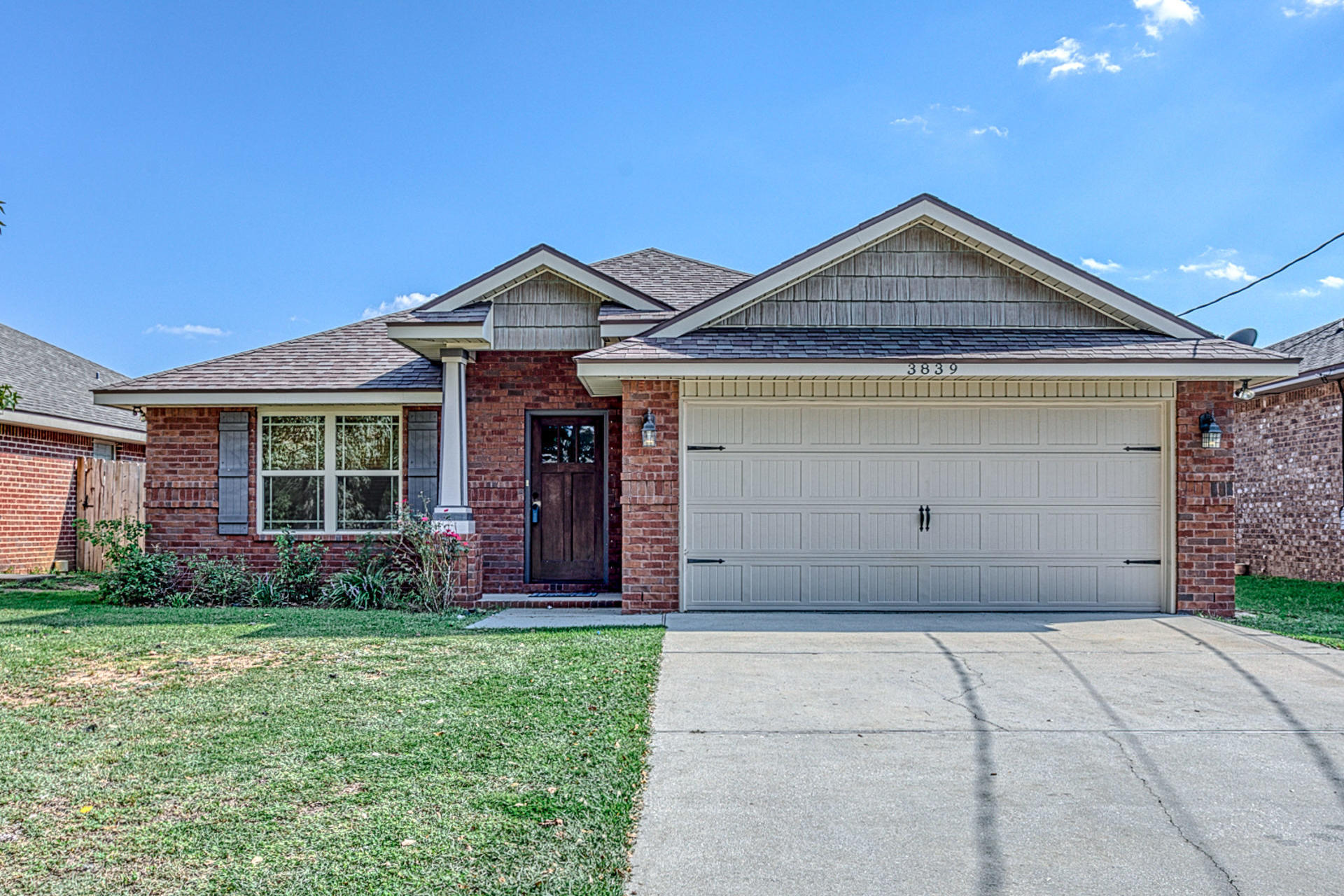 WELCOME HOME! NEW CARPET & PAINT!!! This 3 bedroom, 2 bathroom all brick home features Craftsman style touches and was built using EARTH CENTS standards, for a more green home and lower utility costs. The curb appeal of the Craftsman-style covered entry with column, Craftsman-style front door, and the Deluxe Vinyl Shake siding above the garage and covered porch make this home stand out! Inside you'll enjoy the open floorplan in the kitchen, dining area, and living room, as well as the split bedroom layout. Some of the custom features you will enjoy in this home are the living room focal wall, constructed of wood plank with a rustic paint finish, 10 foot ceilings, crown molding and wide baseboard trim in the main living areas of the home,