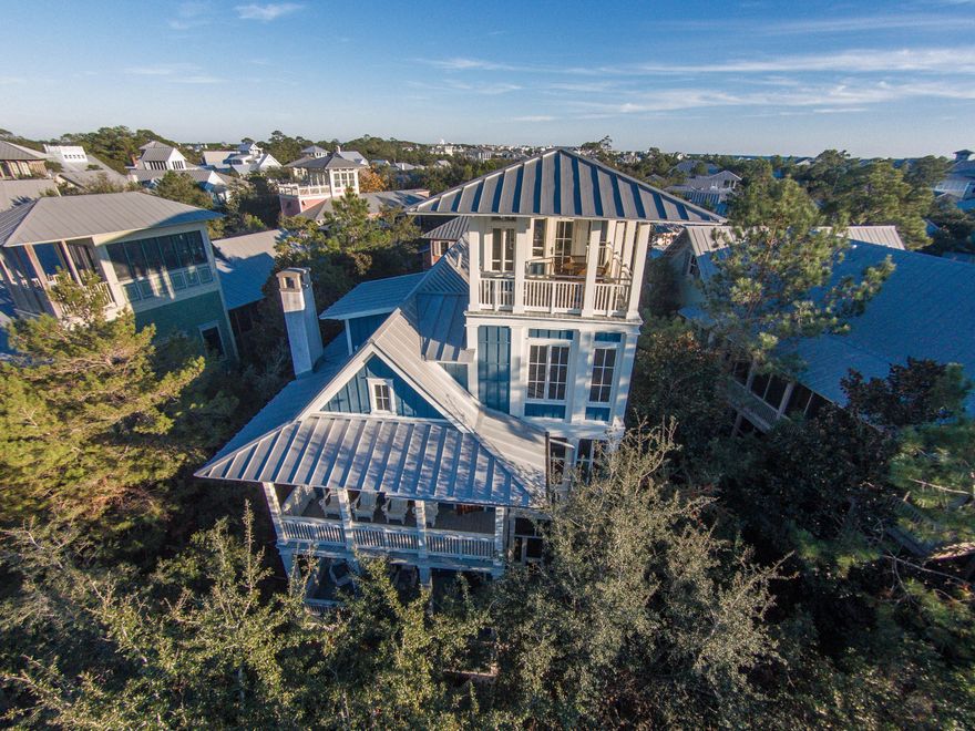 *Entered for comp purposes* Nestled on the quaint Western Lake Drive in the heart of the Park District of WaterColor, this Phase I home exemplifies family living. Each of the six bedrooms has its own private bathroom and there are numerous, spacious gathering areas for the whole family to relax. Immerse yourself in unspoiled beach living paired with hints of New England influence in this 3,600 square foot classic beach cottage designed by Huffman Tarmey and built by famed Seaside & WaterColor builder Peter Horn of Artisan Builders.Breathtaking panoramic views of the Gulf of Mexico, Western Lake, and the rooftops of neighboring Seaside & WaterColor homes can be savored from one of the highest points in WaterColor, the 4th level look-out tower. The 3rd level is completely finished in solid pine 1x6 tongue & groove planks, and offers an intimate family room with equally stunning views, a bunk room, full bath, and a secret room concealed behind an in-wall bookcase. The 2nd level contains a master bedroom with attached porch, a sleeping porch with double swing bed, a library area with custom mahogany bookcases, and two bedrooms with accompanying full baths. The main level contains a large family room that opens into the dining area and professional kitchen with stainless steel appliances and granite countertops. Also on the main level is an additional master bedroom with full bath that connects to the fully-enclosed outdoor shower. The detached carriage house offers an open living space with a bedroom, bathroom, full kitchen, balcony with views of Sunset Ridge, and a loft area accessible by a sliding library ladder. The one car garage below is complete with an additional washer & dryer for the carriage house guests. 

The quality craftsmanship and extreme attention to detail in this exceptional custom-built home will satisfy even the most discerning buyer. The interiors are finished in solid pine boards with 1x8 tongue & groove wainscoting and 1x6 tongue & groove ceilings. Premier local artisan David Higgs crafted custom cabinetry throughout the entire home. Each bathroom was custom designed by illustrious Waterworks tile and evoke the colors of the ocean and beach. A custom masonry fireplace in the family room features a coquina style, hand-made, seashell finish. The flooring throughout the home is wide-plank, site-finished solid oak. Multiple sets of mahogany french doors can be found throughout the home leading to the over 1,400 square feet of outdoor living areas, including a screened-in outdoor dining area. 