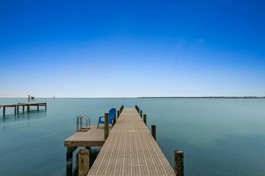 This Choctawatchee Bay waterfront custom built home features 4 bedrooms, 3 baths plus oversize garage.  A home to build memories and a place you can be yourself.  Walk outside onto your own private back yard with wildlife, fresh air and nature.  A place to hang out all day!  Only 11 miles by car or 5 miles by boat to the Destin Harbor's day and night life with an abundance of shops and restaurants for all age groups.  This house is a best kept secret.  100 ft of waterfront property which sits on a unique peninsula.  Home features a concrete bulkhead which is a rare find and a 60' thru flow pier with swim deck (2021).Enjoy the large covered patio with room for outdoor cooking while listening to the sounds of waves & birds.