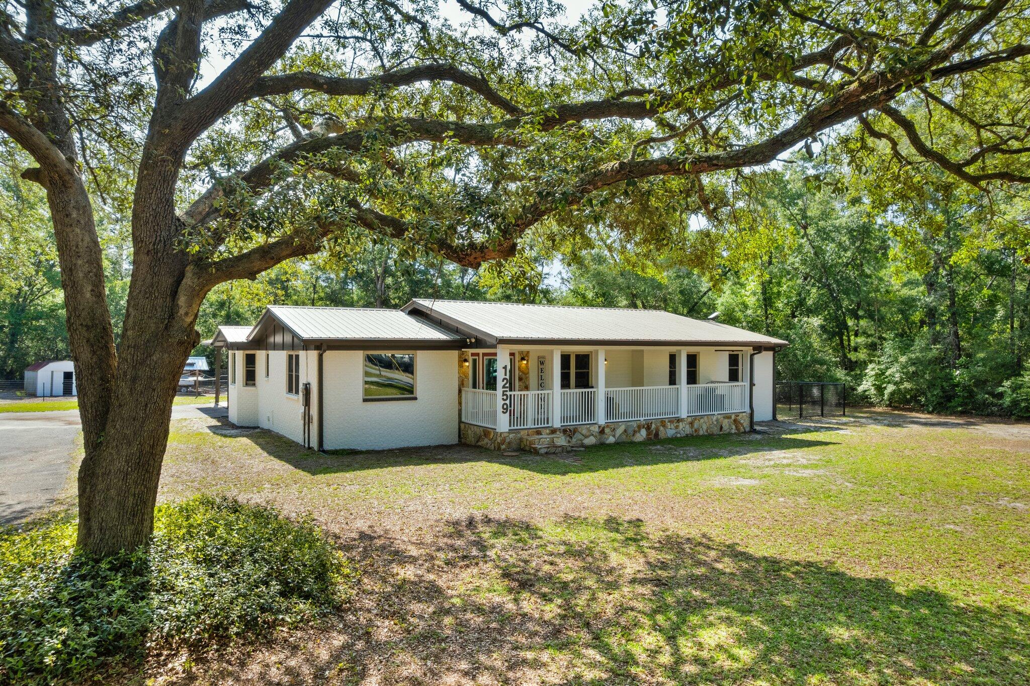 Discover this charming 4 bed, 2 bath, spacious 1914 sqft split floor plan nestled on a 1-acre lot. Recent updates include hot water heater-2025, exterior doors-2024, full kitchen and appliances-2023, HVAC-2022, roof and windows-2018 and newly installed LVP flooring and paint throughout. The modern kitchen boasts new granite countertops, cabinets, and family size pantry. Spacious kitchen and dining area floor plan create a warm and inviting atmosphere. Ample RV parking and a 2-car covered carport. Large workshop (with AC, refrigerator, microwave and 30-amp RV power) and separate storage shed (with 50-amp RV power) offers plenty of extra space. This non-HOA community has access to a community boat launch (1 mile) on Black Creek, leading to the scenic Choctawhatchee Bay. Just 4 miles from Freeport's Publix and a short 20-minute drive to shopping, restaurants, entertainment and the Emerald Coasts stunning white sand beaches of 30A. Seller to pay up to $1000 at closing for the buyers Home Inspection and Appraisal. Home qualifies for a 100% USDA loan. If the home appraises for more than the purchase price, the buyer can finance in the closing cost up to the difference.