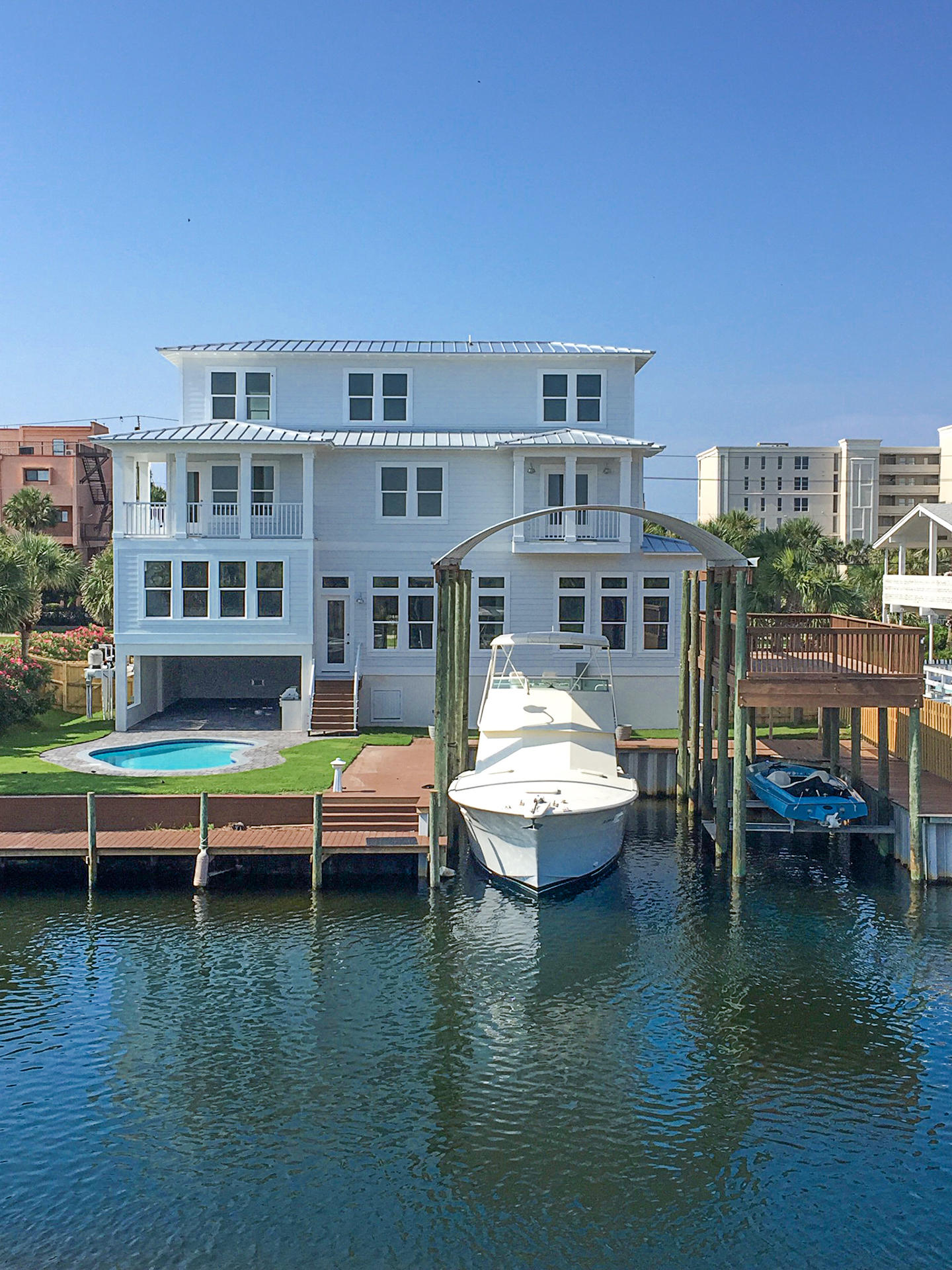 BRAND NEW Boat Lover's dream home! Ideally located in the heart of Destin with two deep water boat slips and a heated private pool overlooking the canal, with easy deeded beach access just across the street. This exquisite waterfront paradise boasts endless high-end features including reclaimed wood flooring, custom gourmet kitchen with all Thermador appliances, marble countertops, and more. Built to last with quality concrete construction and steel beams throughout. After a fun day on the water in your own boat or at the beach, relax on the balconies to enjoy weekly and holiday fireworks. This impressive home absolutely must be seen to appreciate. Perfect property for primary residence, second home, or lucrative rental investment.