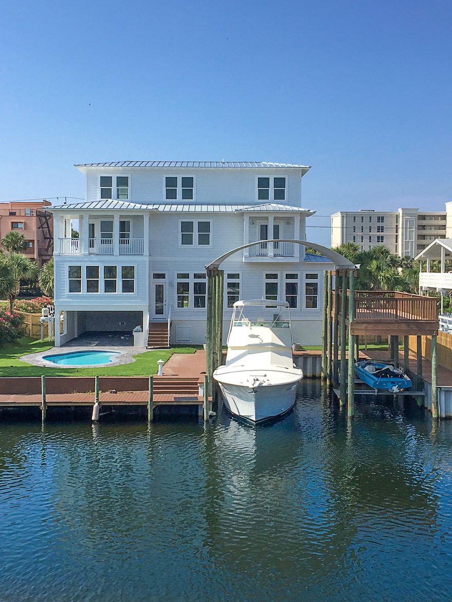 BRAND NEW Boat Lover's dream home! Ideally located in the heart of Destin with two deep water boat slips and a heated private pool overlooking the canal, with easy deeded beach access just across the street. This exquisite waterfront paradise boasts endless high-end features including reclaimed wood flooring, custom gourmet kitchen with all Thermador appliances, marble countertops, and more. Built to last with quality concrete construction and steel beams throughout. After a fun day on the water in your own boat or at the beach, relax on the balconies to enjoy weekly and holiday fireworks. This impressive home absolutely must be seen to appreciate. Perfect property for primary residence, second home, or lucrative rental investment.