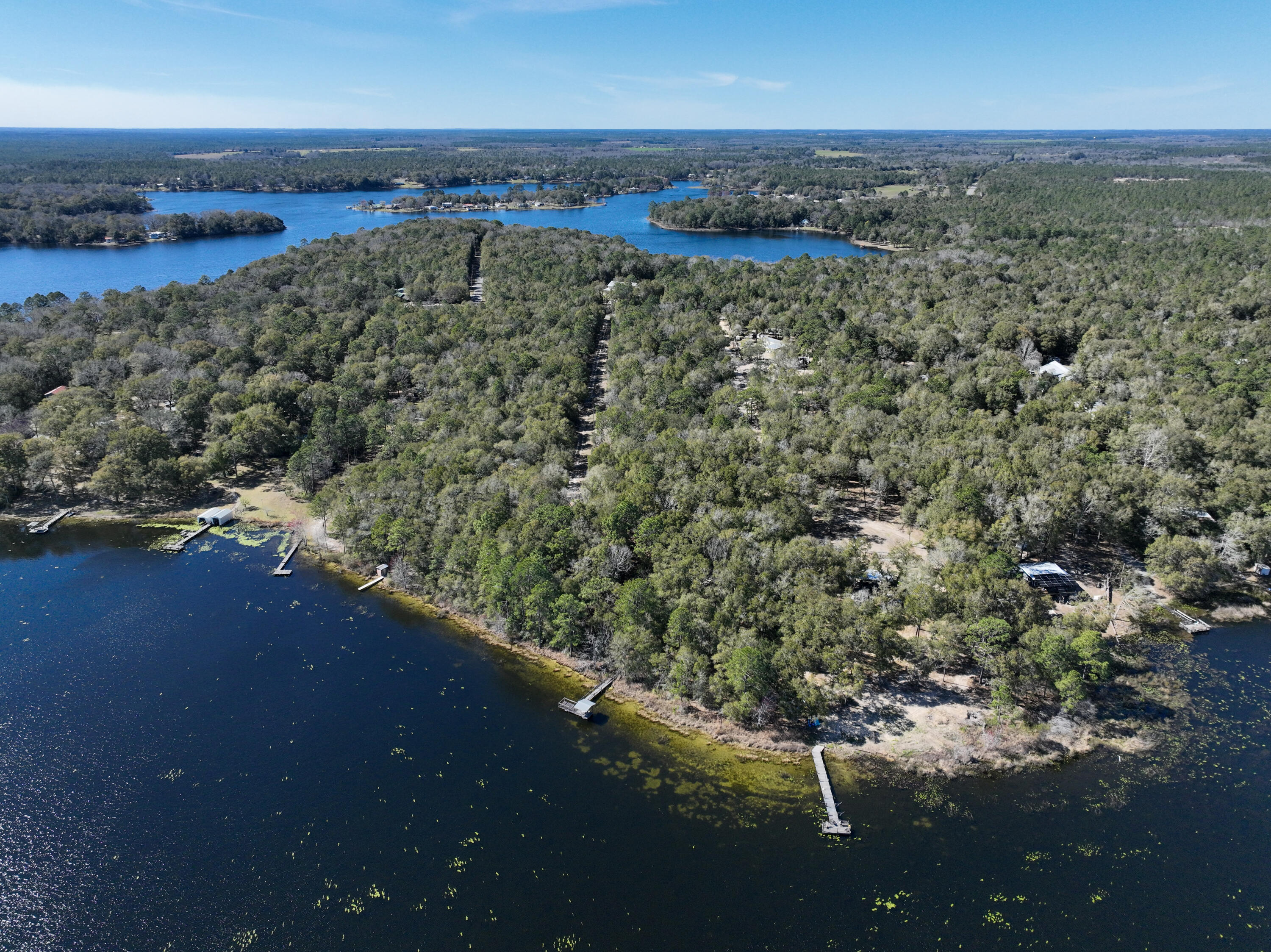 Under contract with a kick-out clause! Welcome to your serene retreat at Lake Holley! This picturesque property spans nearly 6 acres, offering a stunning wooded and shaded lot perfect for relaxation and outdoor adventures. Whether you're an avid angler or simply looking to unwind in nature, you can bring your fishing poles and enjoy the tranquility of the lake at your doorstep. There is a dated 2/2 mobile home on the property that had storm damage and not habitable at this time. Full power and septic are already in place. This idyllic setting promises the perfect balance of privacy and natural beauty, making it an ideal location for your dream home or getaway. Don't miss your chance to experience the charm and serenity of Lake Holley!