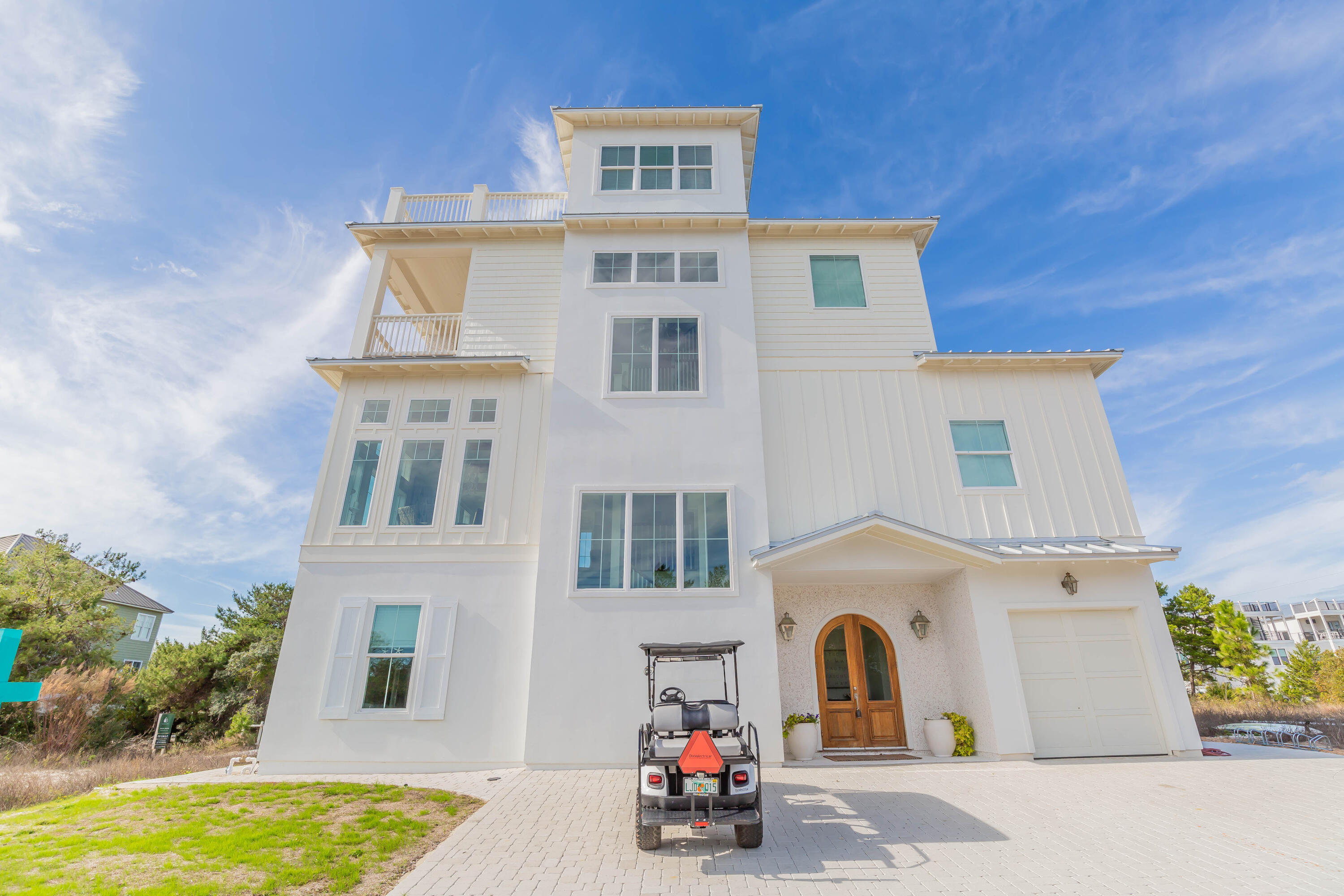 Four floors of indoor and outdoor living space with sweeping Gulf views are just the tip of the iceberg at this luxury coastal retreat. It offers more than 1,000 square feet of inviting outdoor living space incorporating a beautiful pool, putting green and multiple porches and balconies providing quiet retreats. The interior design is truly noteworthy having been featured in numerous glossy magazines including Country Living. Custom touches by Truth and Co. interior designers encourage you to linger and admire the characterful mahogany doors and tabby shell stucco fireplace among other features. A glittering chandelier adds a touch of decadence to the formal dining nook.