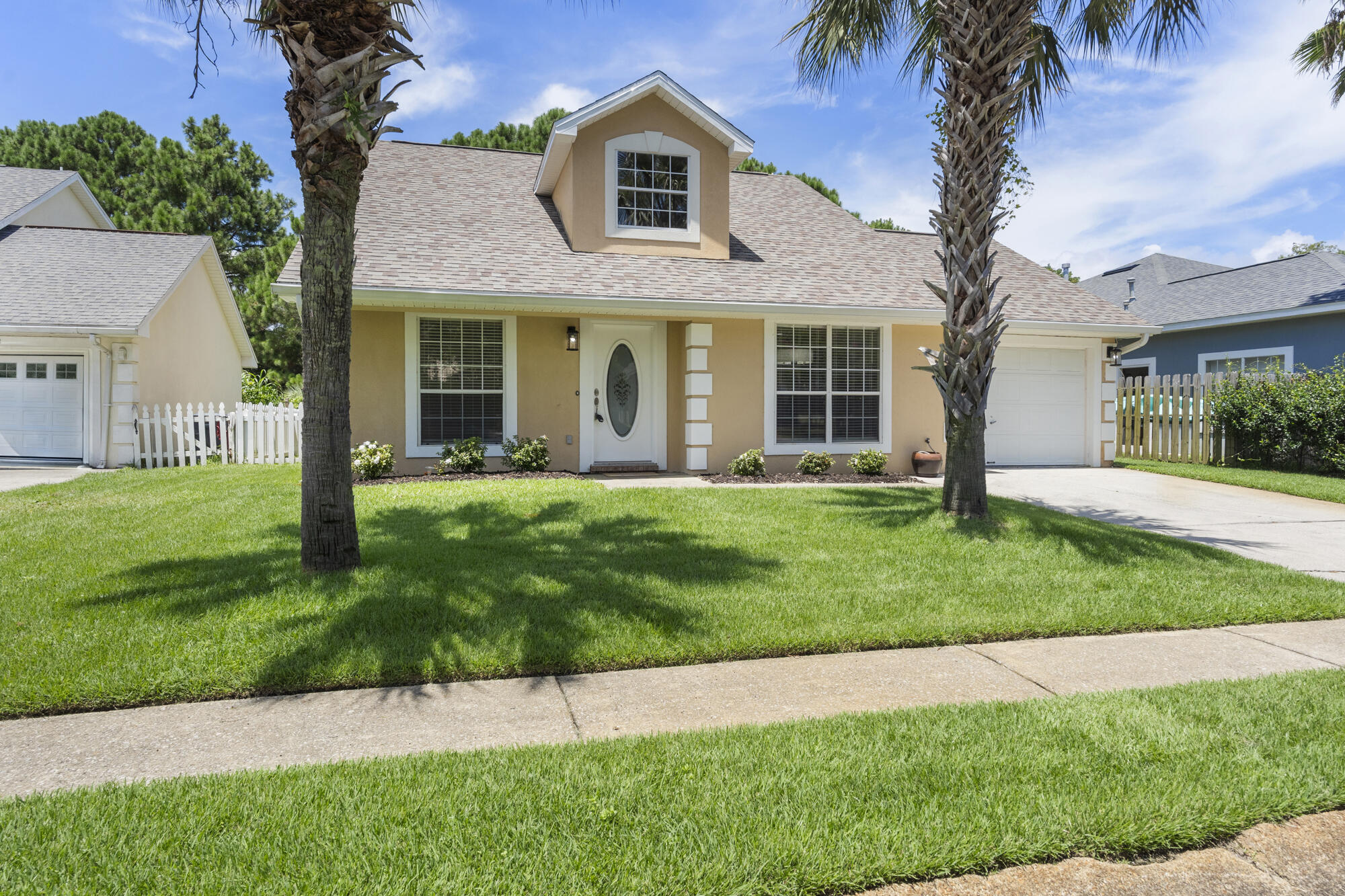 Move in ready charming 3 bed 2 bath Bayside Community home is priced to sell! Pull up to the beautifully maintained coastal cottage with palm trees shading the lawn and new shrubs and mulch lining the front. Step inside to open concept living, Stainless steel appliances, fresh paint and new fixtures throughout. The first floor is complete with professionally cleaned tile, fresh new carpet up the stairs and wood floors throughout the master bedroom. Outside, unwind on the wooden patio, perfect for entertaining or relaxing, overlooking a lush lawn framed by a classic white picket fence. Sway gently in a hammock strung between shady palms, with serene pond views just steps away through a convenient fence gate. The enjoyment continues with the community amenities pool, party pavilion, children's playground, shuffleboard and pier allowing for full enjoyment of the Choctawhatchee Bay. Centrally located between Destin and Sandestin with easy access to great restaurants and shopping just a short walk to the Silversands Outlets. This coastal charmer is ready to welcome you home!