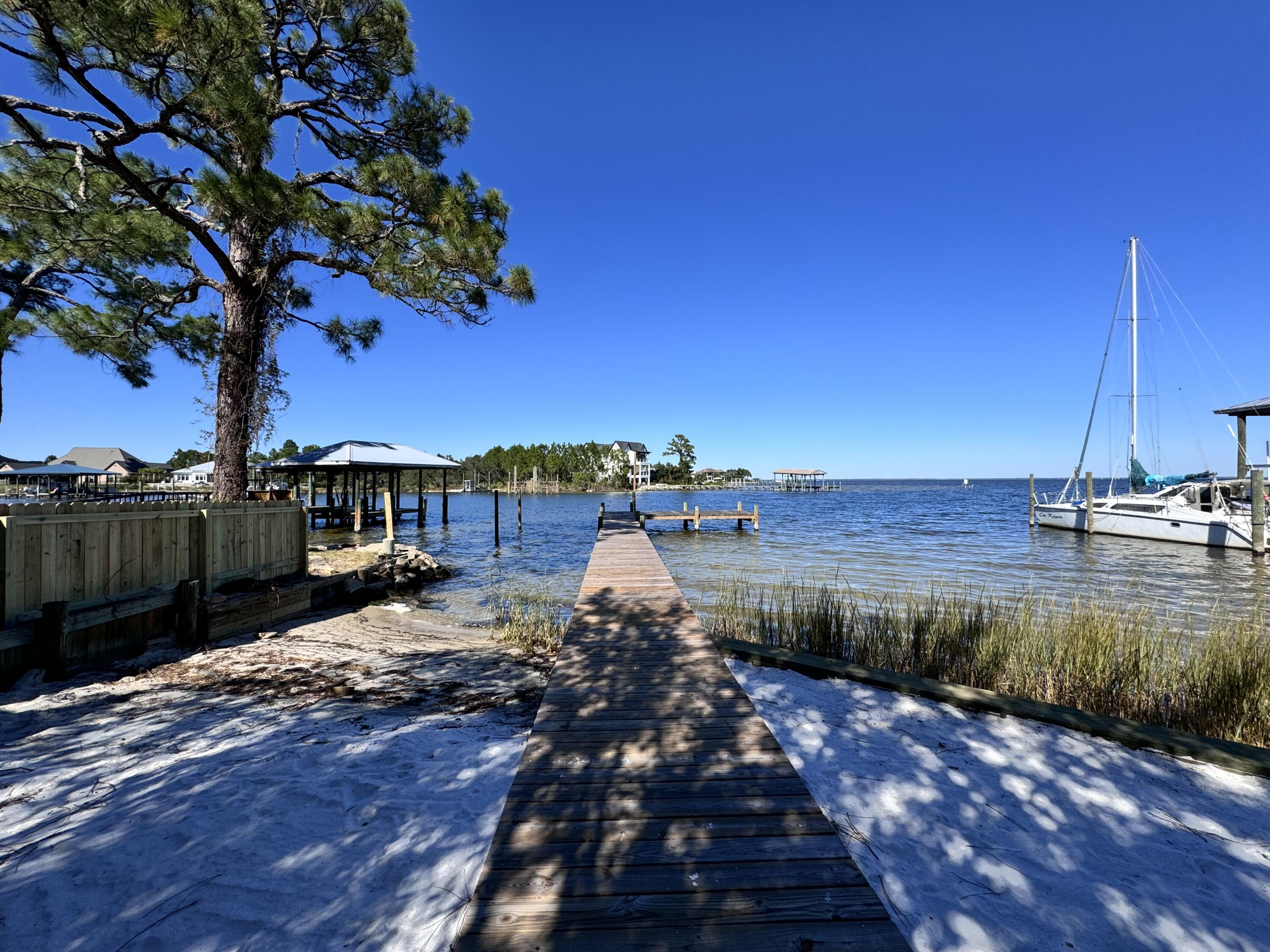 If you're looking for a place to relax and take in the scenes of the water and mother nature, you've found your place. Convenient to the beaches on 30A, just minutes from Destin where you can enjoy great food, shopping, and entertainment. Here's your opportunity to own a waterfront home on the Choctawatchee Bay. The view is breathtaking, the lot is large and the home has 2023 installed hurricane impact windows and sliding glass door. Trex deck and stairs, 3-year old roof. New seawall and planks on the pier. Great place for a boat requiring deep water. The bonus is a separate room (3rd bedroom)  on the lower level with a full bath and small kitchenette - great for a guest room, office, or rental space!