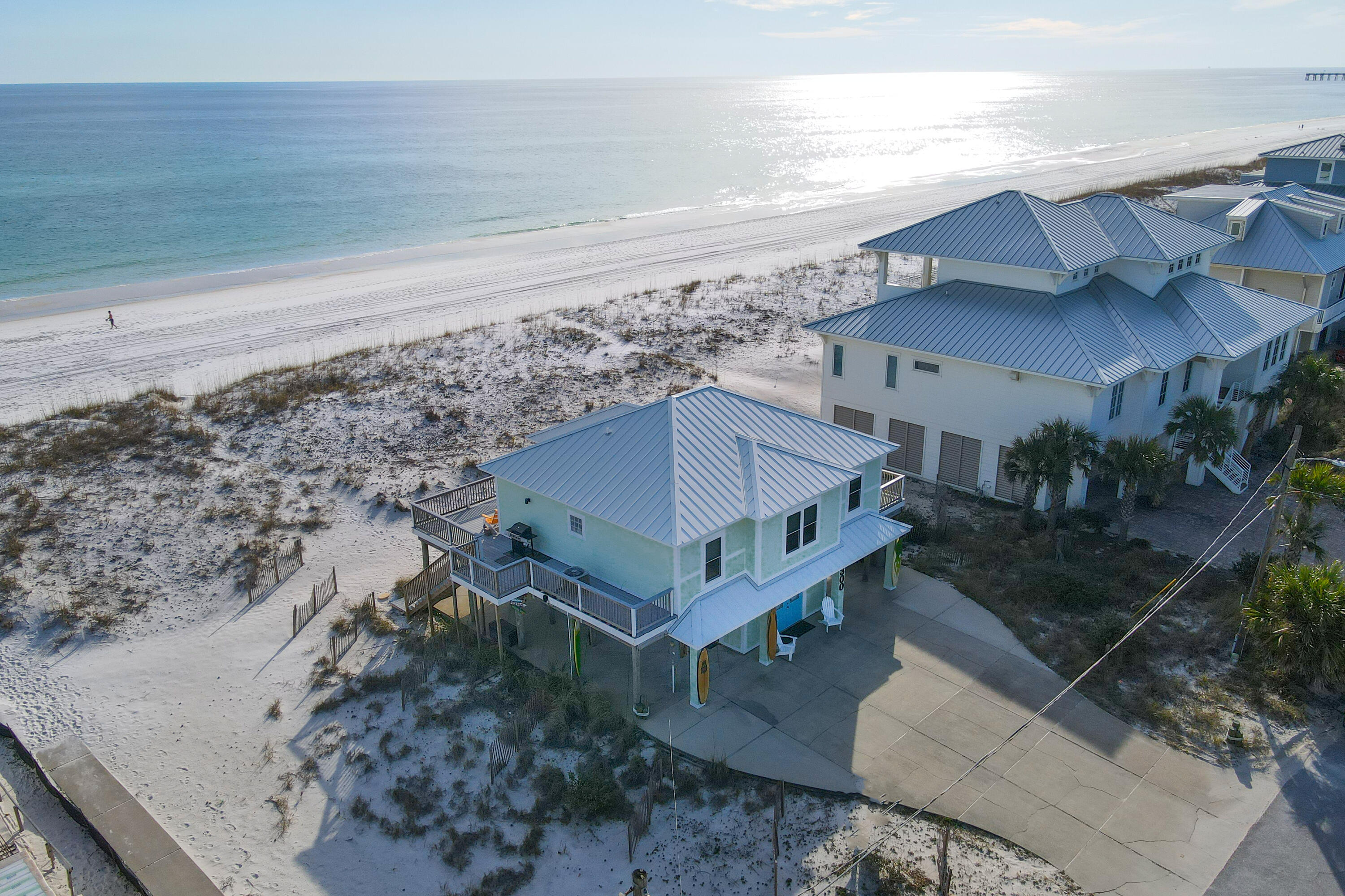 This delightful, Gulf front home, 300 Ariola Drive, is now available. Located directly on the Gulf of Mexico, this home is ideally situated to enjoy the sugar white sands and beautiful emerald blue waters that make Pensacola Beach so special. Views from the Gulf facing deck, kitchen and living/dining area are as good as it gets! Just walking into this bright, happy home will put you into a vacation frame of mind, and sitting on the deck will make you never want to leave! This updated home features Hardi siding and a long life standing seam metal roof making maintenance and cost of ownership low. Buyer to verify room dimensions and square footage. All furnishings convey and this is turn-key, ready to go.