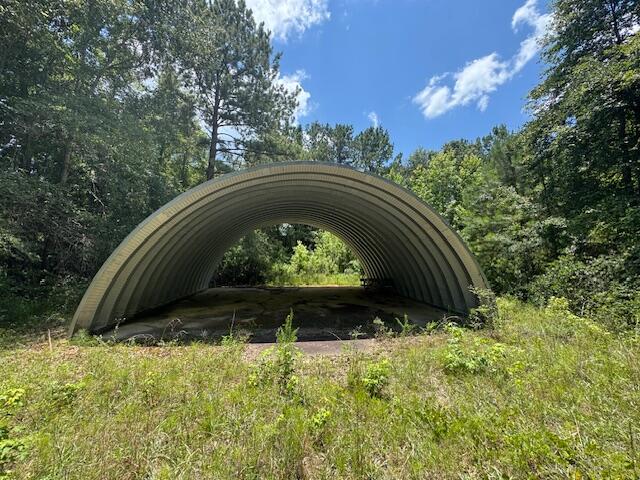 62.84 Acres (+ -) with 30 x 40 (RV sized) Staninless Steel Arch Storage building on concrete pad. Great homesite possibilities with a spectacular view. Excellent for farm, development or hunting. Property is unimproved but has great potential. Well exists/has been drilled but is not operational. Call us for appointment to see!