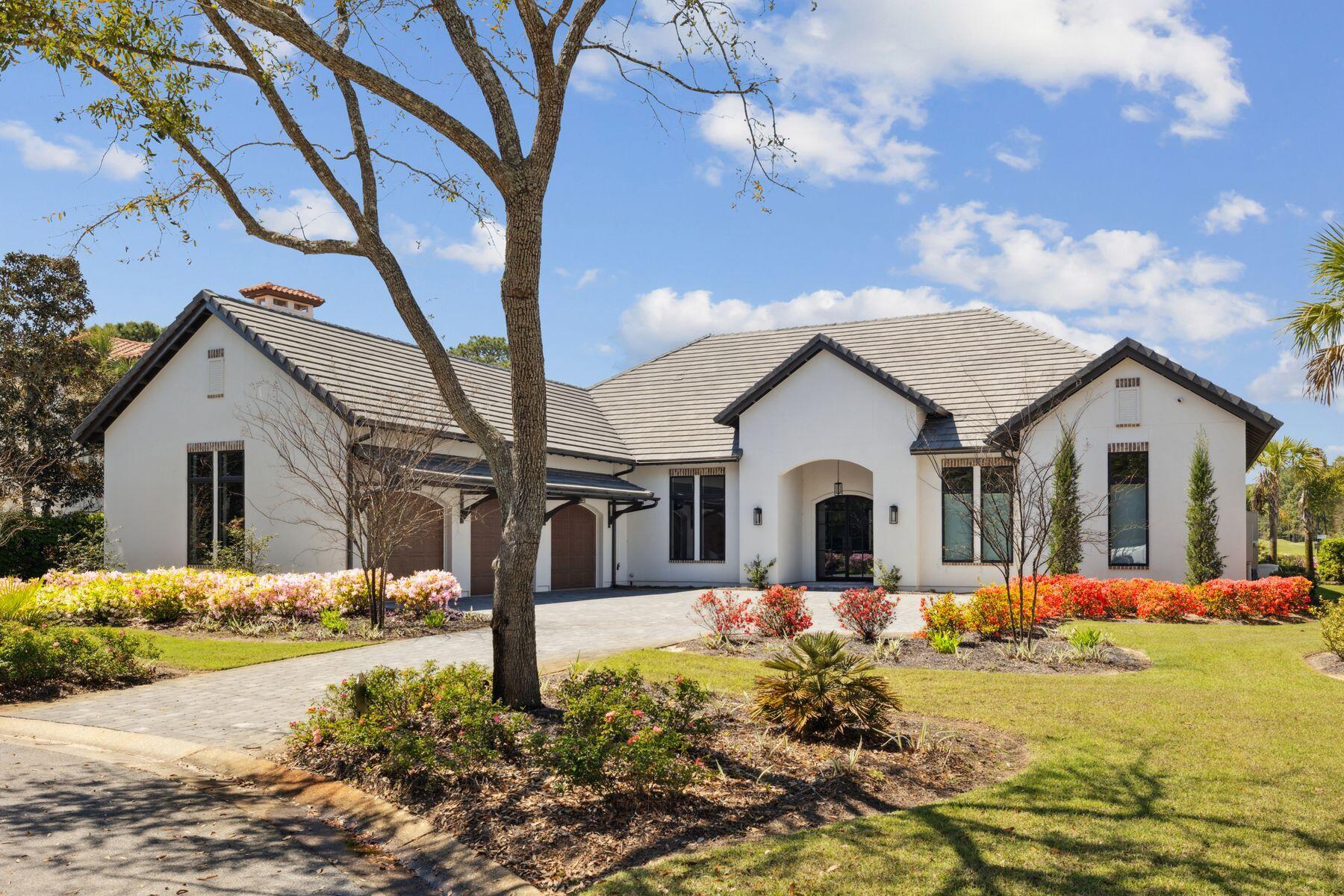 Built in 2022 to exacting standards by Coastal Custom Homebuilding, this outstanding Mediterranean-style residence showcases the best of everything. Sitting on a prime, almost half-acre lot with expansive golf and lake views, this very private home has a stunning pool and spa, lofty rooms, high-end fixtures and coveted chef's kitchens both indoors and out. Laid out for living all on one level, it boasts a split floor plan with four beautiful bedrooms served by five exquisite bathrooms. A sweeping driveway heralds the approach to the home, providing ample parking and access to the insulated three-car garage with attic storage above. A covered entrance invites you inside, where the vast great room will take your breath away. Extra-tall ceilings draw the eye upwards to the deep crown molding and sparkling designer light fixtures. Beneath your feet, a runway of engineered light oak flooring carries you through the entire home. A dedicated dining area with garden views is perfect for entertaining, while a study keeps work separate from pleasure. The drama continues with dark wood beams anchoring the spacious sitting area. A realistic gas log fire provides a natural focal point. The kitchen is an epicurean masterpiece with sleek quartzite countertops and well-planned cabinetry. High transom windows deliver abundant natural light, echoed by the tall cupboards with lighted display shelves. A wishlist of high-end Monogram and U-Line appliances include a 48-inch built-in refrigerator, a smart dishwasher and a stainless microwave drawer. A huge custom hood hovers above the 48-inch six-burner professional range, where meals can be created and served on the expansive island. Perch on cushioned stools and enjoy casual dining or pre-dinner drinks at this social hub. Sliding glass doors provide a natural flow outdoors where alfresco living is at its zenith. Beneath a mansard roof, the screened pool and jetted spa offer tranquil views of the manicured rear yard, lake and fairway leading to Burnt Pine's fifth hole. In the covered porch area, a hotel-worthy outdoor kitchen is fully equipped with a refrigerator, sink, ice maker and a grill beneath a pecky cypress hood. An outdoor fireplace and a TV make this a delightful area for lounging and entertaining in all seasons. Retire to bed in the magnificent master suite. The spa-like master bathroom has elegant marble flooring, designer tile and a freestanding bathtub for leisurely soaks. There's ample space for the oversized walk-in shower and a quartzite twin vanity with a kneehole dressing table. Beyond the doorway, the walk-in closet is fully customized with abundant shelves, drawers and hanging rails. Additional features of this exceptional residence include two tankless water heaters, audio-visual home technology and a security system. Burnt Pine at Sandestin is famous for its championship golf courses, but amenities extend to include tennis, watersports, a 223-slip marina, award-winning dining and endless shopping on Grand Boulevard and the Village of Baytowne Wharf. There's even a shuttle to carry you and your cooler effortlessly to the shores of the white sandy beach.