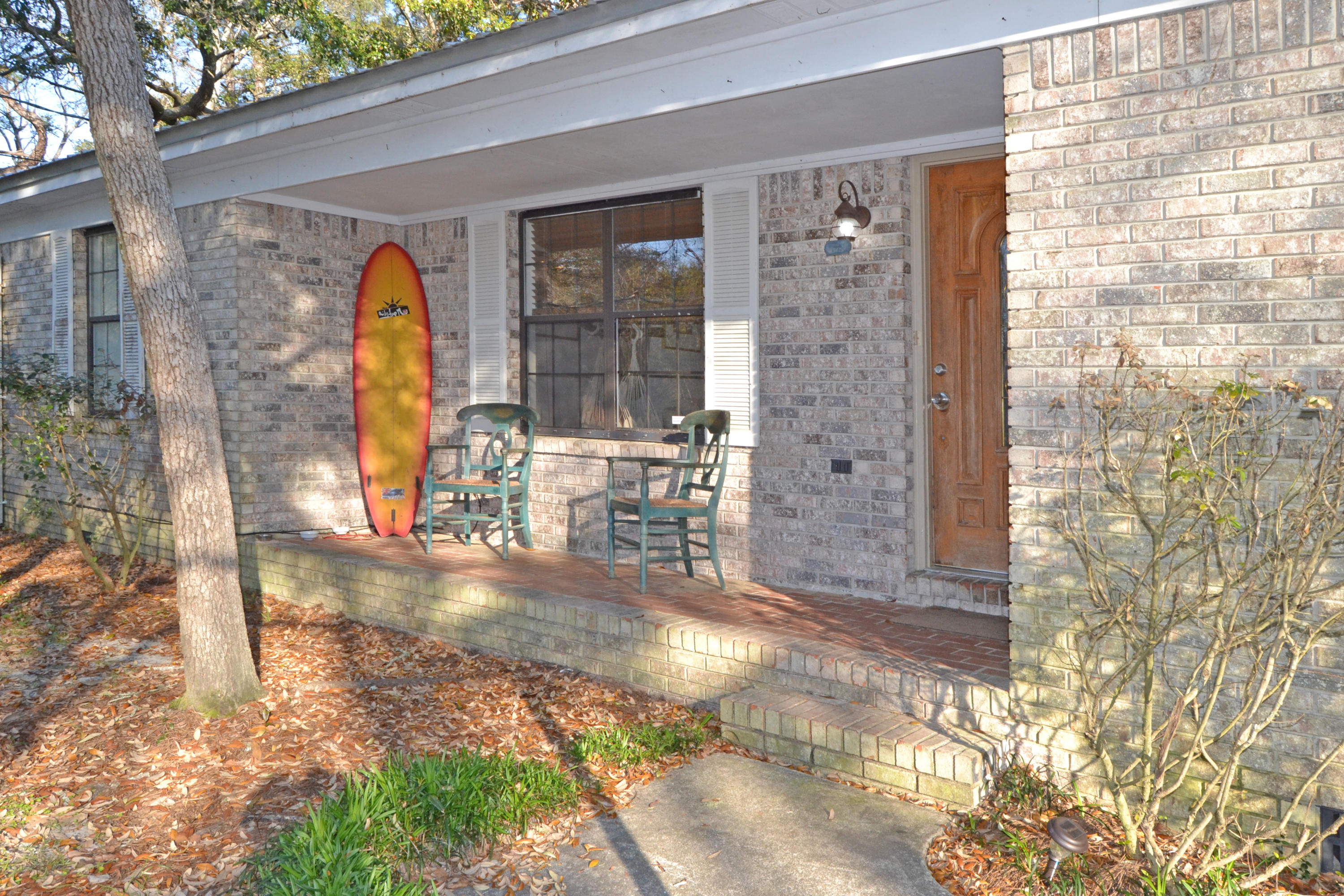 Best deal south of HWY 20! This all brick home with lush landscaping, mature oaks and magnolia trees lends to a very private setting. Home has a new metal roof and comes complete with a 16x20 workshop in the backyard. The workshop is a perfect spot for the hobbyist, or could be turned into a guest house. There is a 220' artesian well for lawn pump/sprinkler system, and/or back-up water supply for the home. The interior has a split bedroom plan for privacy and a cozy corner stone fireplace (propane gas) in great room, tile floors in main living areas. The 15'X 23' Florida room and/or 4th bedroom is currently used as an office. . All measurements to verified by buyer and is offered as is.
