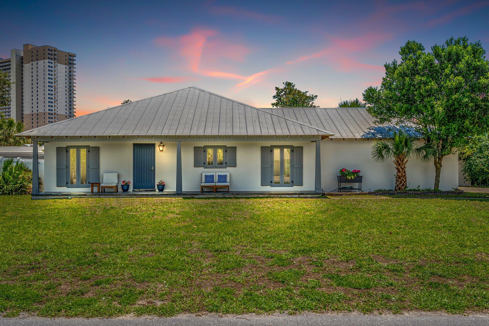 This almost entirely renovated beach home sits on approximately .25 acres in an amazing location just a block from the Gulf of Mexico with a peek of the water. It is convenient to two public beach accesses and less than a mile west of Pier Park. The property is zoned Commercial High Intensity, which allows for short term rentals and more, and there is no HOA! Professional rental projections indicate $72,000+ annually. You will enjoy the Rosemary Beach style & design at a fraction of the cost while being a quick ten minute drive to 30A. The home has an open concept design with 3 beds, 2 baths, and a two-car garage. Recent improvements include new LVP flooring and trim throughout, interior & exterior paint throughout, a new bathroom vanity and additional tile in the primary bathroom, and upgraded lights. Stainless steel Kitchenaid appliances and washer and dryer are approximately 2.5 yrs old and HVAC is less than 6 yrs old. High-end original details like tongue and groove wooden ceilings, custom wooden doors, custom fireplace (has not been hooked up by current owner), exposed rafter tails along the roof, wooden functional shutters & poured concrete block construction give this home more character than other options at this price point.
Major beautification is underway to Front Beach Rd and Hwy 79, which are the main roads near the property. This project includes new sidewalks, bike lanes, wooded landscaped medians & underground utilities. It is scheduled to be completed by the end of 2023. This area boasts numerous restaurants & a grocery store within a short walking distance.
The large lot provides ample space for expansion or additional improvements. Currently, a portion of this area is wooded and the rest is used for additional parking and a secondary driveway next to the main brick paver driveway. The property is zoned Commercial High Intensity, which in addition to allowing short term rentals, provides greater flexibility for additional improvements and small building setbacks. Despite this, the property is surrounded by residences on all sides so the neighborhood has a relaxing residential feel. The front yard has a recently serviced and repaired sprinkler system connected to inexpensive City reuse irrigation water. The backyard has a vinyl privacy fence, covered porch, wooden deck & natural landscaping.
The possibilities for this beautiful home & property are endless & this neighborhood will become more and more sought after as the City's nearby beautification project progresses. All facts are deemed reliable, but should be verified by buyer.