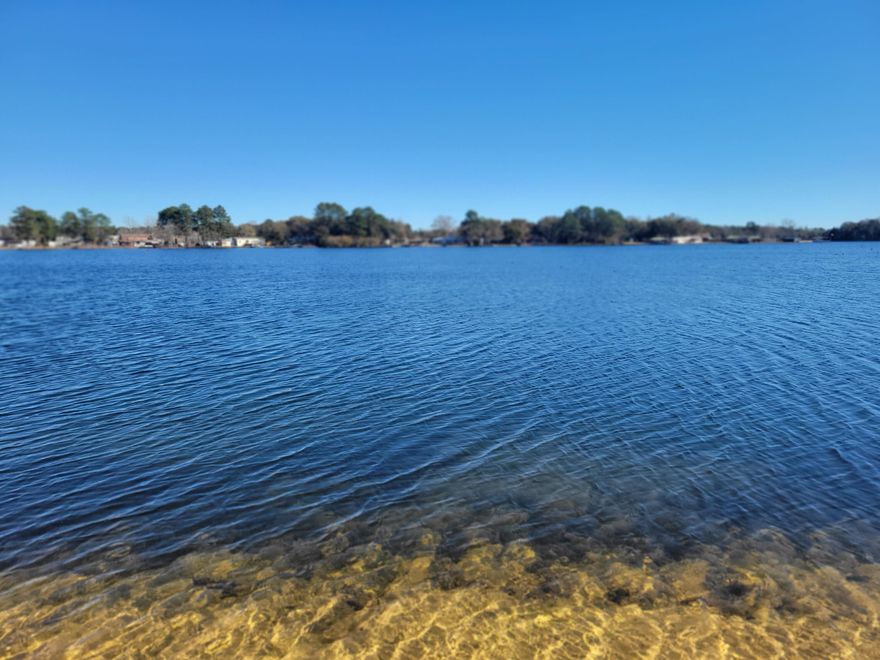 JUST DRASTICALLY REDUCED 3/8/2023---MOTIVATED SELLERS--be sure to check out this waterfront home on Kings Lake.  Includes a 1512 s.f. manufactured home built in 1989.   A total of 2 lots included:  the upland lot and a waterfront lot for a total of appx. 1 acre (subject to an up-to-date survey).  Upper lot has a privacy fence and cleared and with water tap and possible septic tank (buyer to verify).  Fixer-Upper manufactured home is located on the waterfront lot.   Materials seen included in the sell. (tools not included).   Kings Lake is known for its record size bass, crappie and bream and catfish and more. CASH CONTRACTS ONLY.