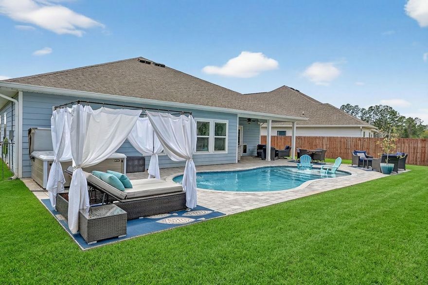 This luxurious 4 bedroom, 3.5 bath single-level home sits on a .25 acre lot overlooking a scenic pond with fountain, offering peaceful views and abundant wildlife. This 3-year-old home features an open design with luxury vinyl plank flooring and quartz countertops throughout. The gourmet kitchen includes a custom pantry, breakfast area, and all kitchen appliances. Enjoy a formal dining room, versatile flex room, and spacious living area with a built-in electric fireplace (gas hookup available for conversion). The custom master closet, built-in shelving in the 3 car garage and laundry room, and thoughtful upgrades add convenience and style. Outdoors, relax in your heated inground pool, hot tub, and fully equipped outdoor kitchen, all within a fenced backyard that's perfect for entertaining.