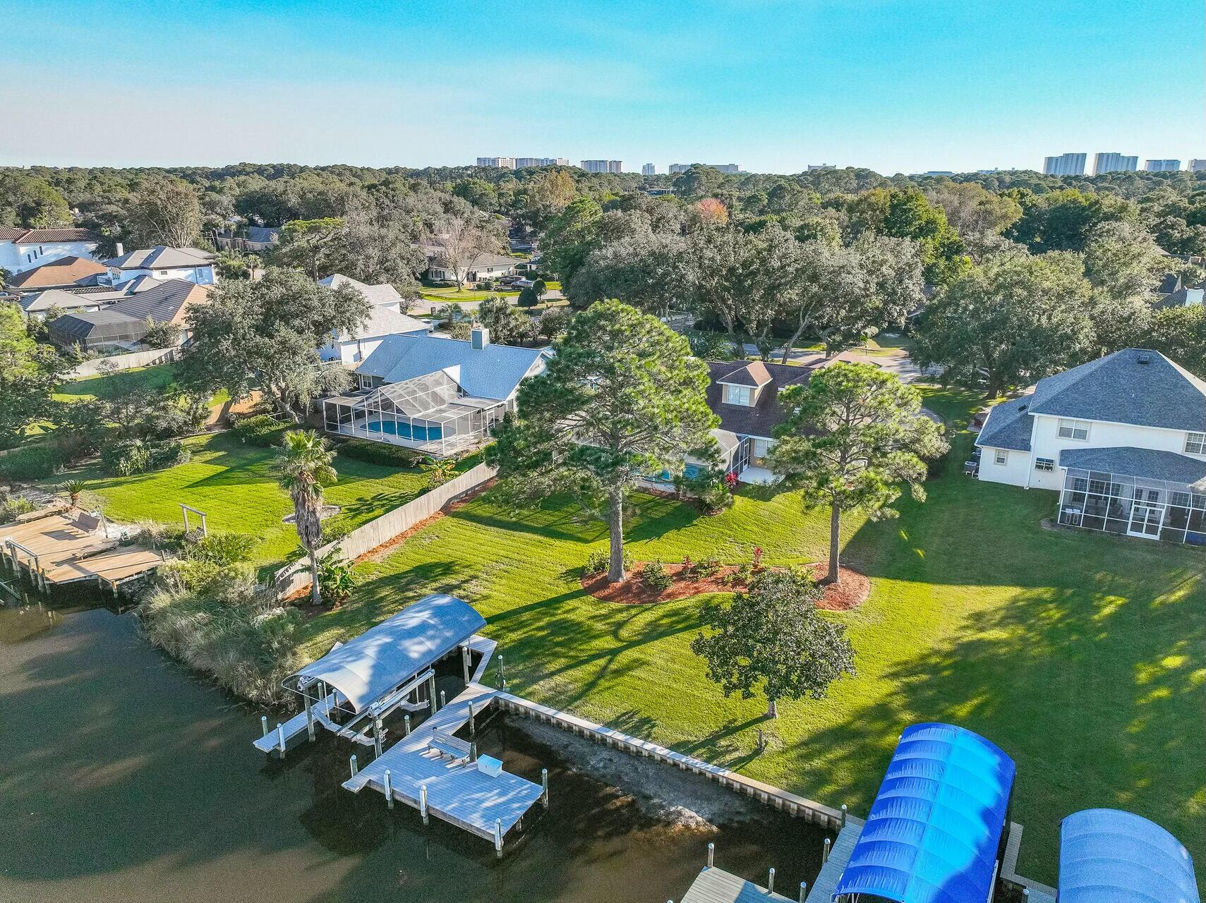 Wishing for a Waterfront Home this Holidays!?! Here is the Home for YOU... Sitting on a Massive 1/2 acre lot with 100' of WATERFRONT, this Meticulously Maintained Home offers 5 Bedroom & 5 Bathroom, Multiple Living Spaces, 2 Car Garage, Screen Enclosed POOL, 2019 Updated DOCK & SLIP on Deep Water Access Indian Bayou! All major components of the home Roof, HVACs, Tankless Gas Water heater, & much more have been updated! Located in the prestigious Golf Community of Indian Bayou, this home is Truly in a Class of its Own! Hop on your Boat & enjoy the day cruising around the Choctawhatchee Bay or take a ride out to the Gulf! The Boat Dock & Slip has been completely redone in 2019, with 16,000 lbs covered boat lift with functional shallow water boat lift cradle. (READ MORE) The composite decking of the dock is a maintenance dream. Sit on the dock bench for a beautiful sunset & watch the fish jump, as you are surrounded by the best nature has to offer. Enjoy a hot day splashing in the pristine Screen Enclosed Pool! Relax on the Large Covered Back Patio overlooking the water & sit around the fire table on a chilly night. Take advantage of 18 Hole Championship Indian Bayou Golf Club & Course at the front of the community. Lifestyle is at the Core of this Home. From the moment you step through the front door, you will fall in love. The entry welcomes guests to a spacious living area with Santa's Favorite, a Gas Fireplace & arched niches. This living area is flanked by a formal Dining Area & Private Office. The Chef's Kitchen opens onto the Living Area with a large Wrapping Bar Area, perfect for entertaining! This professionally-equipped Kitchen with Five Star Gas Range with Dual Fuel Ovens & professional Hood with Heat Lamps, Pot Filler, & Warming Drawer will truly impress the Chef! The kitchen is provides ample storage in cherry cabinets, granite counters, & stainless appliances to include dishwasher, microwave, ice maker, & Newer French Door Refrigerator (2023). Off of the kitchen is an informal Breakfast Nook & Family Room. The Family Room can be made private with Double Pocket Doors. The 1st Floor also offers a stunning Master Suite with French Doors leading out to the covered patio & pool deck. The Mater Bedroom offers an en-suite, spacious, & beautifully remodeled Master Bath with separate soaking tub, sizable Walk-in Shower, separate toilet room, & Large Walk-in Closet. On the opposite side of the home, on the 1st Floor, is a secondary Bedroom or Bonus Room, & a Full Bathroom for Guests. The Second Floor offers 3 Additional Oversized Bedrooms & 3 Additional Bedrooms. The Home also offers multiple storage spaces, large walk-in pantry, attic space, & 2 storage closets in the Garage. There is also a large separate Laundry Room. Thrive in this well thought floor plan, with desirable open flow, while still maintaining individual spaces for everyone in your family. Home is being SOLD FULLY FURNISHED & MOVE-IN READY, just in time for the Holidays!

Looking For Peace of Mind... All Major Components have been Updated!
Roof Replaced with ice & water barrier on the entire roof - 2015
2 Electric HVACs Installed, with Variable Speed Heat Pump, 10 kW  - 2015
Tankless Rinnai Gas Water Heater - 2022 
Electric Panel Replaced - 2024
Exterior Painted with Elastomeric Paint - 2015
Full Dock Update with composite decking, Covered 16,000lb Shallow Water Cradle & Lift - 2019
Pool Enclosure Rescreened - 2021
Transferable Termite Bond
Updated Insulation to make the home more energy efficient.
New Refrigerator - 2023
Waterlines in Kitchen redone with shutoff under sink.
Washer & Dryer Included
Full Renovation of 2nd Floor Bathroom with Walk-in Shower (in north right side bedroom) - 2015
Updated All Glass Shower Doors in 4 Bathrooms - 2015
Replaced Sprinkler Pump on well - 2024
Security System

Indian Bayou is Centrally located in the heart of Destin, but it still remains private & has low HOA fees, with Community Security Service. Close proximity to Dining, Shopping, & Entertainment. Most importantly is the close proximity to our pristine, white sand beaches, with Henderson State Park located just over 3 miles away. No detail has been overlooked; this truly distinctive home has something for everyone! Do not miss this opportunity, it is Priced to Sell!