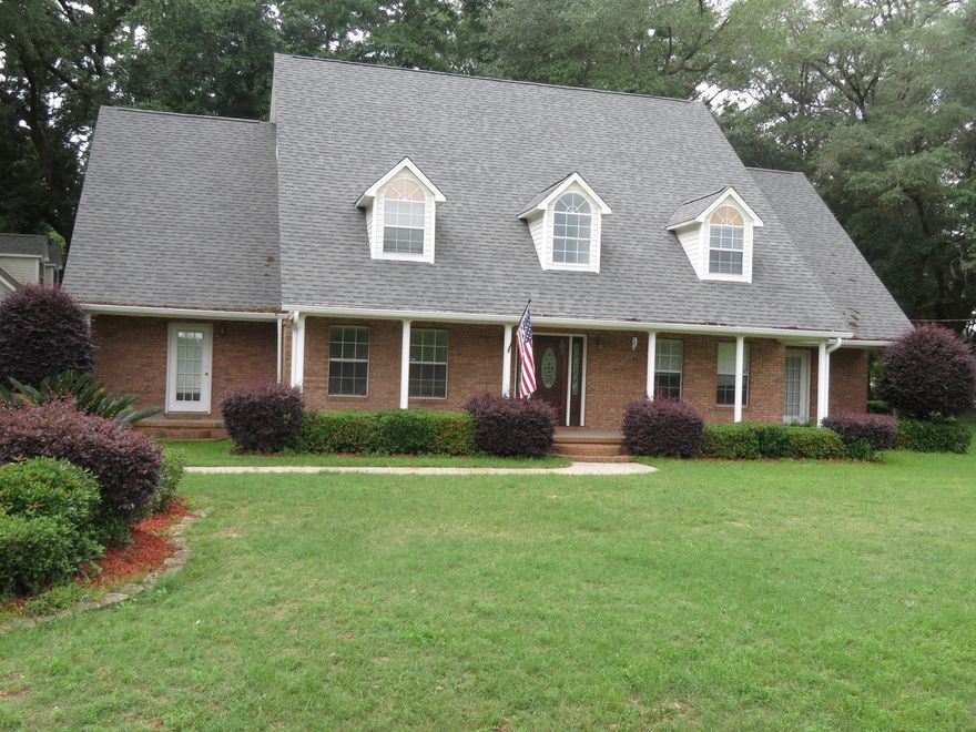 Lots of extras with this Colonial Home located on 1 acre of land, beautifully shaded by large majestic oak trees. Only a mile from shopping and schools. Conveniently located in Stafford Estates and overlooks a stocked pond in front of the home. 3 porches on the front and 2 on the back, plus an expansive patio all compliment this home. Tray ceilings in the Living and Dining Rooms. You will love the Kitchen with its granite counters, beautiful oak cabinets, corner pantry, and stainless appliances. In the evenings enjoy sitting on the front and back porches! Master Bedroom suite is located downstairs opens to the porches on the front/back and has a large walk-in closet, separate tile shower, whirlpool garden tub and oversized granite double vanity. Bedrooms 2, 3, and 4 are upstairs. Bedrooms 2 & 3 share a Jack-n-Jill Bathroom and Bedroom 4 has its own bathroom. All 3 bedrooms adjoin the 14x11 Loft, which has a gorgeous view of the pond and is open to the 2-story foyer, complete with curved stairway. The oversized 2-car garage has the finished area above which is identified as the 5th Bedroom, complete with it own full bathroom, water heater, combined heat & cooling (window unit). It makes a great place for guests or one of the kids that want their own space!  Come and view this property today.
