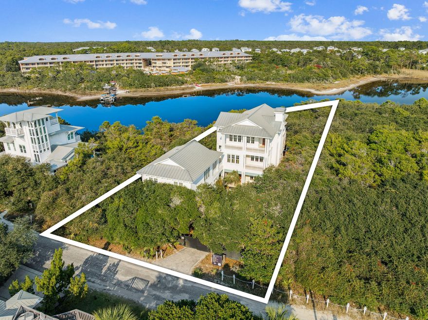 Designed with entertaining in mind, this lakefront residence in Blue Mountain Beach sits on Big Redfish Lake, one of the world's rare coastal dune lakes, offering peaceful lakefront living with the Gulf just across the street. Spanning approximately 5,276 square feet, the home features thoughtful design, high-end systems, and refined finishes throughout. The first floor offers 12-foot ceilings, recessed lighting, and a well-equipped kitchen ideal for hosting, complete with Sub-Zero appliances and a raised ventilation system over the stove. A custom pantry includes a dedicated juicing area with its own sink. A nearby half bath and elevator access to all levels add convenience.

The second floor is anchored by a private primary suite featuring Brazilian walnut flooring, a spa-like bathroom, a large walk-in closet with custom shelving, built-in sound wiring, and a kitchenette. A secondary guest bedroom, built-in bookcases, and an additional kitchenette with a microwave, sink, and beverage chillers provide flexible living options. A large patio with lake views connects directly to the carriage house, creating seamless indoor-outdoor flow.

The third floor is designed for entertaining, offering Brazilian walnut flooring, a gas fireplace, automatic window shades, ceiling speakers, a projector, theatre seating, two Sub-Zero wine coolers, a half bath, and a spacious lakefront patio. The elevator was serviced and inspected in 2025.

The gated outdoor space includes a pool with screened enclosure, irrigation system, direct lake access, and a private dock with power and water. The home is supported by three HVAC systems, including two geothermal units, one newly installed in 2025, along with a conventional system added in 2023.

The 812-square-foot carriage house offers a private bedroom with two closets, a full bath with walk-in shower, and a dedicated laundry room, ideal for guests or extended stays.

Located with easy access to the Timpoochee Trail for biking and walking, this home offers proximity to everything Scenic 30A has to offer. Sugar-white sands, emerald Gulf waters, fine dining, beloved local dives, and favorites like Blue Mountain Beach Creamery are all just moments away, delivering a rare combination of coastal dune lake living, Gulf convenience, and elevated design in the heart of Blue Mountain Beach. Contact us for more information or a private showing.



All information is deemed reliable and provided for informational purposes; buyers are encouraged to independently verify all details.