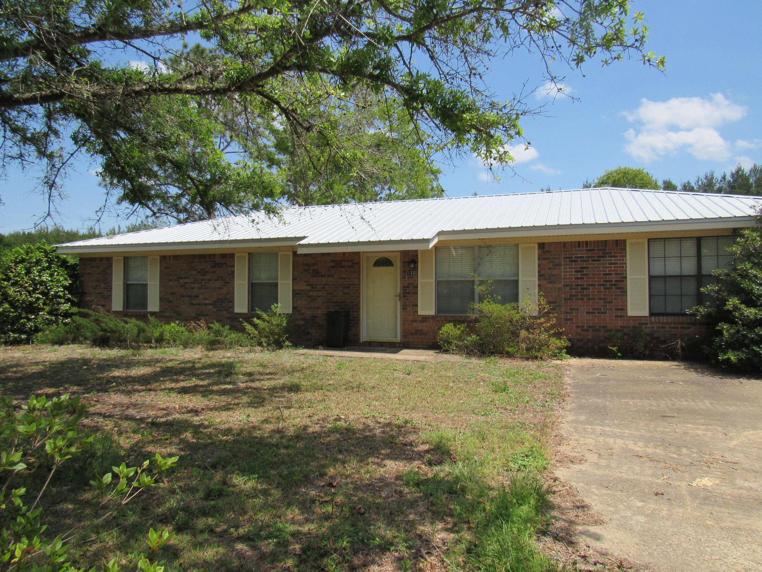 Price Reduced for Great brick rancher on ONE LOT ONLY (.77 Acre) in a well established neighborhood. This home has 3 bedrooms, 1 & 1/2 baths, new metal roof and interior has been previously upgraded. Attractive kitchen with Corian style counter tops, tile floors, Kenmore cook top stove, double door refrigerator, built in wall microwave and oven. Oversized family room (15x24). Master bedroom has a walk-in closet and a half-bath. Easy to show. Home is located close to town on a paved street. Priced to sell. NOTE: Seller is firm on price and will pay no buyer closing costs. Note: Parcel ID number shows two lots, but this listing is for ONE LOT (Lot 8) and the house only. Storage shed is being given no value.