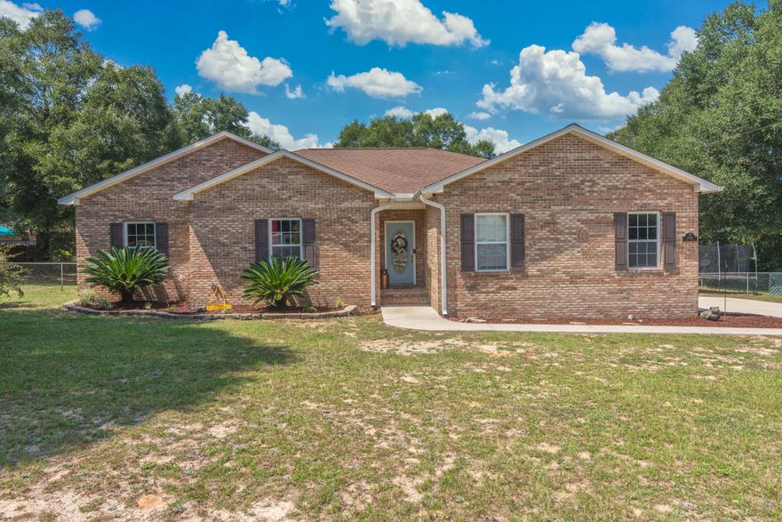 Best of both worlds - quiet country living but still minutes from restaurants, entertainment, and shopping! Located on an acre, this beautiful brick home home features 3 large bedrooms, 1 spacious bonus room, and 2 full bathrooms - the inside is complete with freshly painted interior, beautiful luxury vinyl plank flooring throughout the living room and bedrooms, tile in the kitchen, dining area and bathrooms, and carpet in the bonus room. Enjoy your large master bedroom and bathroom complete with a double sink vanity, soaking tub perfect for relaxing baths, and a walk in shower. The open backyard features a beautiful screened in pool perfect for entertaining! Schedule your showing today - you won't want to miss this one!