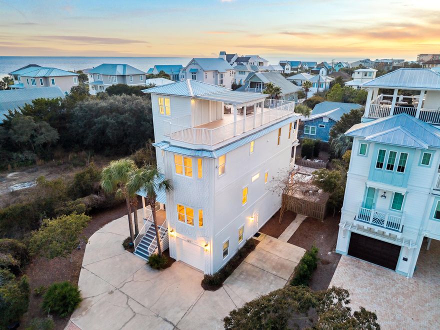 Just 100 yards from deeded beach access to the sugar white sand, this renovated coastal retreat offers Gulf views and exceptional indoor and outdoor entertaining. The private pool anchors a fully fenced backyard oasis designed for relaxed afternoons and effortless hosting, while the rooftop deck showcases panoramic Gulf views and an outdoor kitchen, the perfect setting for sunset gatherings above it all. Multiple balconies overlook the landscaped yard and pool, inviting doors to remain open and coastal breezes to move easily through the home. The third floor living space captures Gulf views across the open kitchen, dining, and living areas, thoughtfully designed for gathering.The fully renovated kitchen blends clean lines with functionality, while refinished wood floors, fresh interior paint, and updated lighting create a bright, relaxed coastal atmosphere. On the first level, a separate living area with kitchenette and full bath opens directly to the pool deck, providing a comfortable and inviting space for family and guests to unwind. A residential elevator connects each floor, making everyday living and hosting effortless. Not rented in over a decade and extensively improved, the home features a 2023 roof, updated HVAC systems, a Rinnai tankless water heater, whole home Sonos audio, Eero mesh WiFi, InvisiGuard window tinting, and approximately 100,000 dollars in updated furnishings. Offered fully furnished and turnkey, this is a rare opportunity to own a deeded beach access property that delivers both lifestyle and long term value.