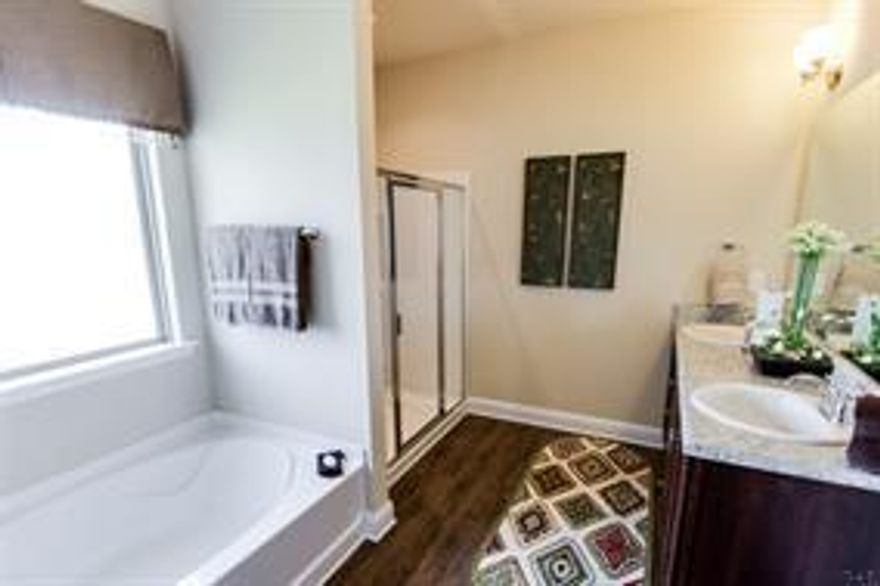 The Lamar is a one story floor plan, featuring 3 bedrooms, 2 baths, covered back porch & 2 car garage. The open kitchen features an island, stainless steel appliances and granite countertops. The kitchen opens to the great room w/ access to the back covered porch. The master bedroom is just off the back side of the house & master bathroom features a walk in closet, separate 5' tiled shower, dual sinks & large tub. Listing Broker/Sales Associate has ownership interest in the property. Photos are of a similar home.