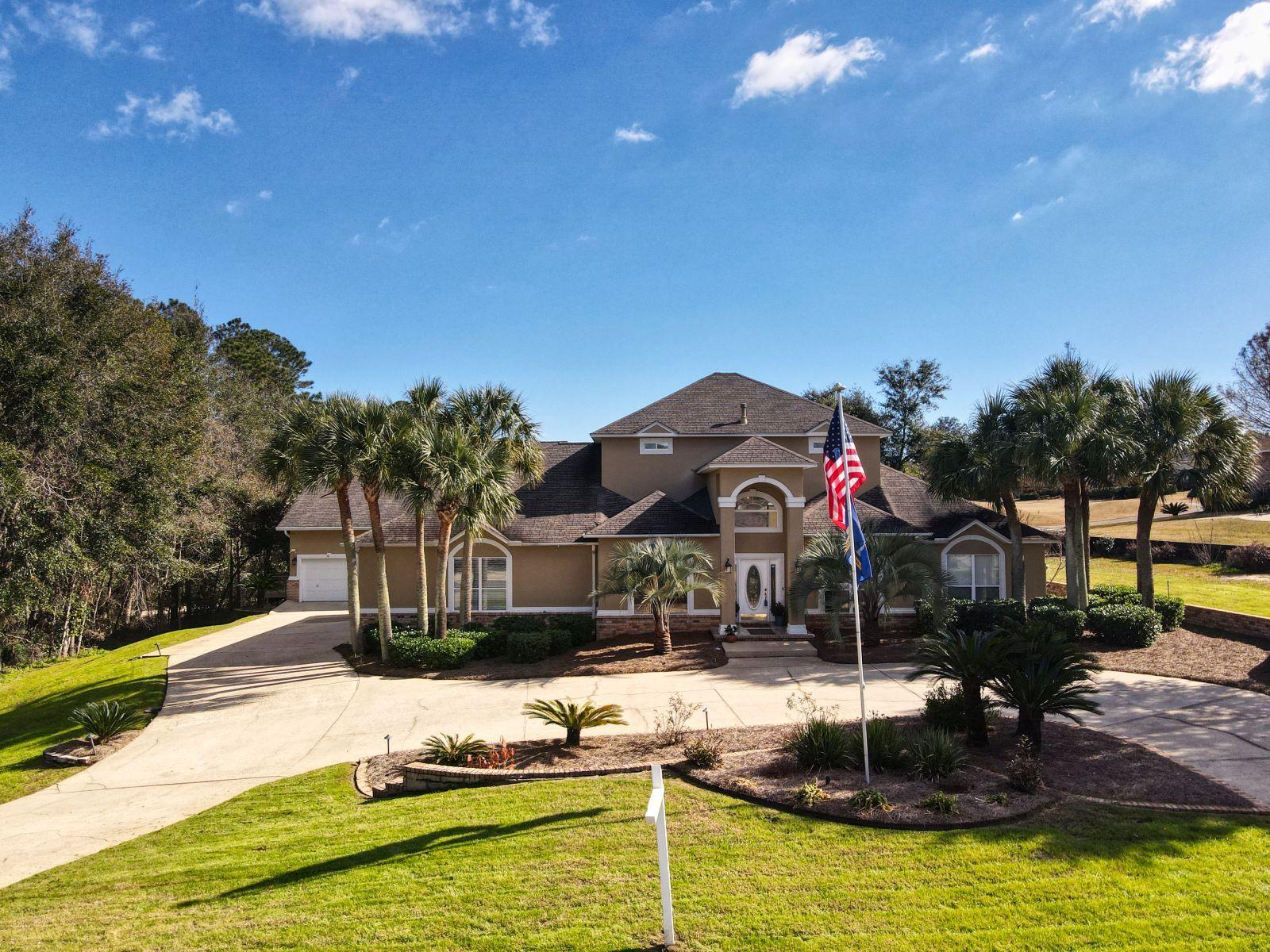 TWO houses on the 5th green of Marcus Pointe Golf Course! Rare, one of a kind property with a main house and a guest house each with their own attached garage. Main house is 3 bedrooms/3 baths with 3647 sq ft. Guest house is 2 bedroom, 2 1/2 bath handicap accessible with 1936 sq ft. Relax outside in your lovely screened, heated and cooled saltwater pool. Screened lanai with an amazing outdoor kitchen..complete with a griddle, refrigerator, tiki bar and beautiful view of the golf course. The main house has a large eat in kitchen and attached formal dining room. Sunken living room with attached music room or additional dining. Upstairs is a HUGE master retreat with fireplace, balcony overlooking the golf course, huge master bath with his/her sinks, walk in shower and garden tub.