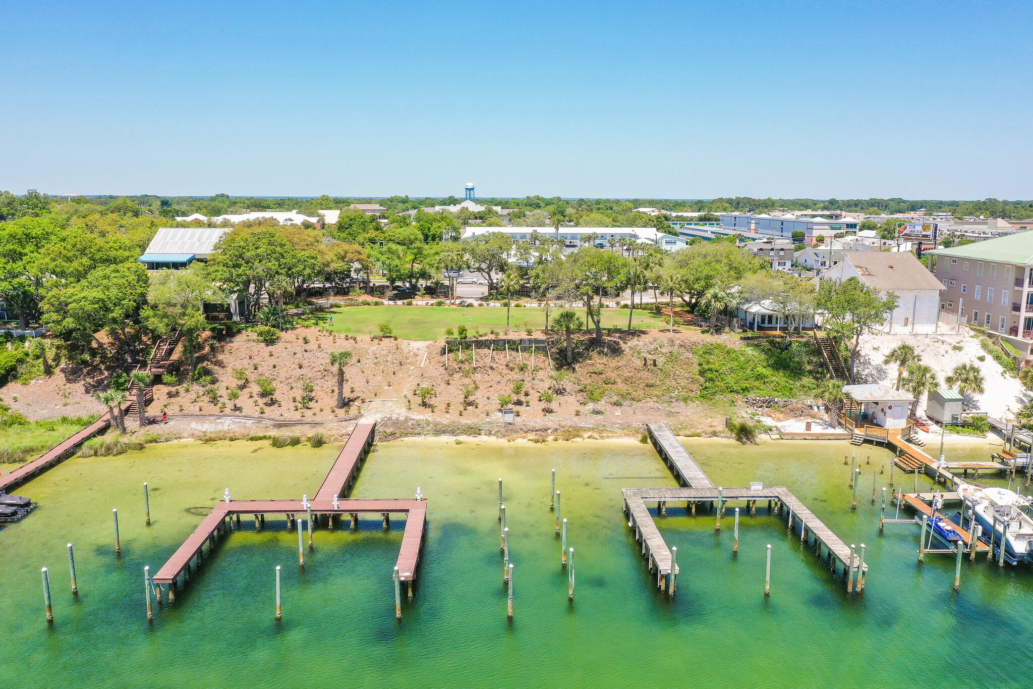 100'' of PRIME WATERFRONT. This .51 of an acre located in the heart of Destin Florida. Large Lot is situated on one of Destin's highest bluff's overlooking the beautiful harbor. Watch the dolphins and lot's of other wildlife in your own backyard! The sunsets are simply amazing and will recharge your soul! If your a fisherman or watersports enthusiasts you will enjoy this property immensely. This is one of 2 lot's available purchase. Buy one or assemble both for a 1 acre waterfront estate. It comes with 4 Deep Water Boat slips per lot that can accommodate large or small boats. The lots have been cleared and ready for you to build your dream home.