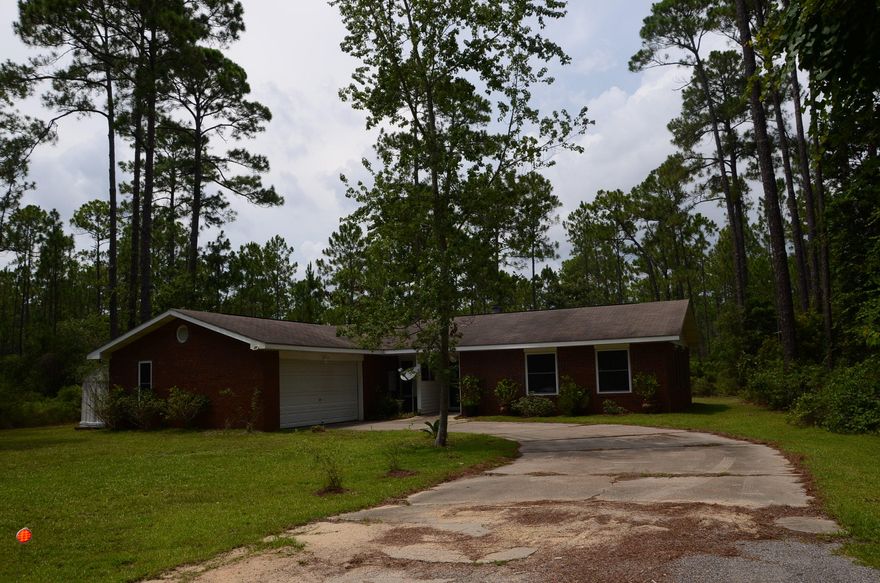 This well-maintained 3 BR brick home on a large lot in a tranquil, secluded setting in Santa Rosa Beach is relatively easy and inexpensive to maintain. It backs up to State owned lands and currently has a vacant lot on either side so it's like living on a peaceful nature preserve only very close to the beaches, shopping, dining, churches, hospital, & entertainment. Major improvements made in 2011 including a new HVAC, new flooring, fresh paint, new double-hung windows meeting the most stringent hurricane protection standards and lowering insurance costs, new patio doors with hurricane shutters, new ceiling fans, and new blinds. The fireplace is wood burning, and all appliances are electric. Please click on ''More'' button for additional details.