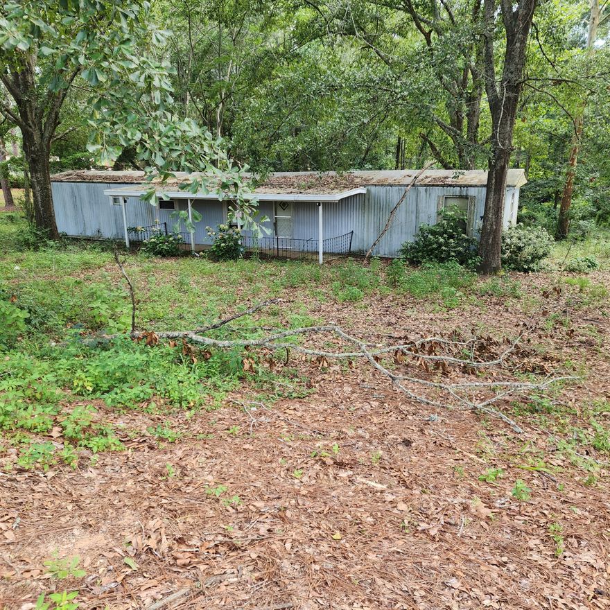 Located in the City Limits of Paxton this is a rare find!!! 2.5 acres on a paved road with city utilities. Lot is wooded and also includes a mobile home no value has been given to.