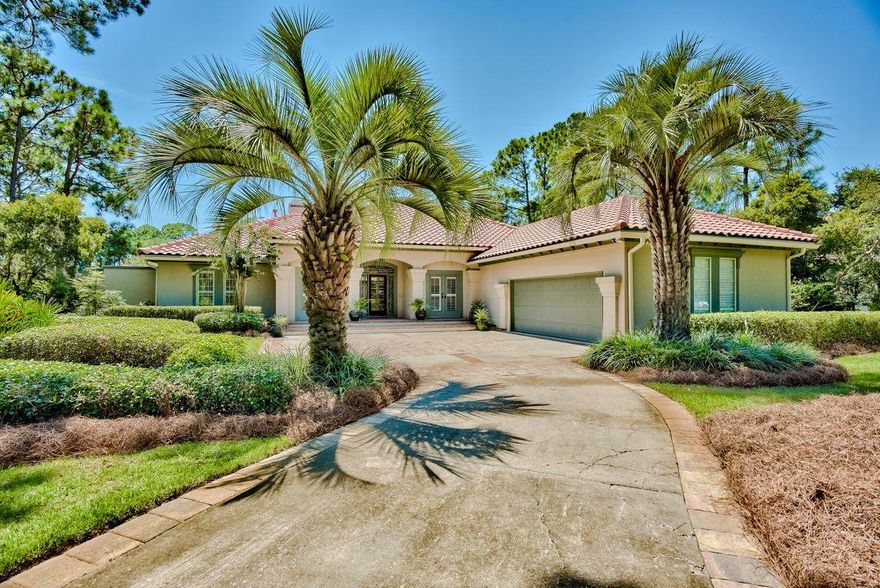 This sophisticated coastal home is on an oversized lot with lush tropical landscaping. The grand foyer is light and welcoming with whitewashed oak flooring providing a neutral foundation for stylish furnishings and tasteful decor. Beige cabinets contrast with dark granite counters in the kitchen, creating an inspirational space for creative cuisine. A breakfast area table and bar provide casual seating. Head into the formal dining area for entertaining before retiring to the sitting room, warmed by the glow from a gas fireplace. Double doors lead out to the screened porch or to the L-shaped pool with blue waters spilling from the sheer descent fountain and a spillover hot tub all accented with glass tile. Lounge on a suntan ledge or relax under the covered terrace.