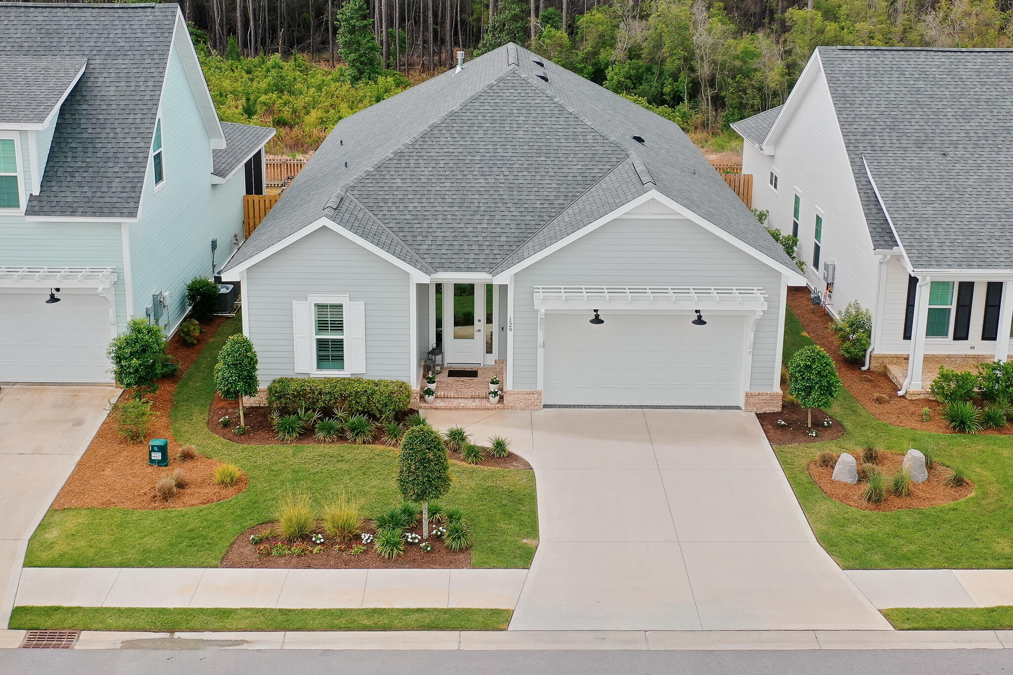 Welcome to the Longleaf Park neighborhood in the heart of the sought-after Watersound Origins community. This stunning, like new, exceptionally well maintained home was completed in 2023 and has $117,445 in tasteful upgrades, more than any other home in the neighborhood. This one-of-a-kind masterpiece is a beautifully designed and upgraded Florida residence with the popular 1,960 sq. ft. Brady floor-plan, four bedrooms, two and a half bathrooms and offers a harmonious blend of modern elegance and coastal charm. Step inside to discover 10-foot ceilings adorned with crown molding, ceiling fans, recessed lighting, plantation shutters and window shades. A beautiful gas fireplace and custom bookcases offer an open-concept layout that seamlessly connects the living, dining, and kitchen areas. The top quality gourmet kitchen features soft-close wood cabinets, an extended spacious island with under counter cabinets, Farmhouse sink, both under and above cabinet lighting, quartz countertops, custom pantry, stylish tiled backsplash, stainless steel appliances and vent hood, KitchenAid wine cooler and a pull out microwave, perfect for both everyday living and entertaining. The laundry room includes a washer/dryer combo and custom laundry sink.
Retreat to the serene primary suite, complete with a spa-like bathroom featuring a double vanity, tiled shower, and large custom walk-in closet. The additional two bedrooms offer ample space and flexibility with a Jack and Jill bath and custom closets. The fourth bedroom, also with a custom closet, offers the option of a dedicated office for the ideal work-from-home setup. Other upgrade features include a tankless water heater and 2-car garage with epoxy coated floor.
Enjoy the Florida lifestyle with an expanded patio and rear privacy fenced backyard, improved landscaping with a picturesque natural view for a peaceful and private outdoor space ideal for relaxing or hosting gatherings. Community amenities include the Village Commons pool, fitness center, sports courts, walking trails, as well as unlimited golf, and generous green spaces enhancing the resort-like atmosphere. The nearby Watersound Town Center provides added convenience with a Publix Super Market and a variety of restaurants and healthcare facilities.
Located just minutes from the pristine beaches of the 30A Emerald Coast, top-rated schools, and a variety of convenient dining and shopping options, this home offers the perfect balance of tranquility and convenience in a premier South Walton neighborhood.
Experience the best of coastal living at 129 Suwannee Drive where comfort meets elegance in a vibrant community setting.