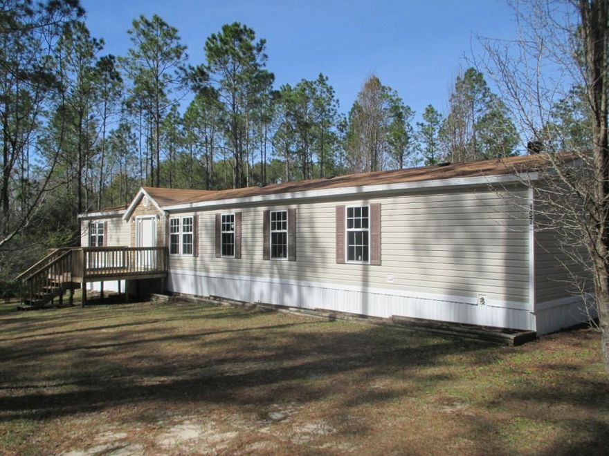 Spacious 4/2 manufactured home on 2.49 acres. Home opens to a living room with 3 bedrooms and a full bathroom to the left. Entering further in the home is the open kitchen/dining area perfect for entertaining. Off of the kitchen is the family room, utility room, and master suite. The master suite features a separate office area. The master bathroom has double vanity sinks, shower, and a garden tub. You can access the master closet from the bathroom as well as the bedroom. Home sits in the middle of the acreage for perfect privacy.