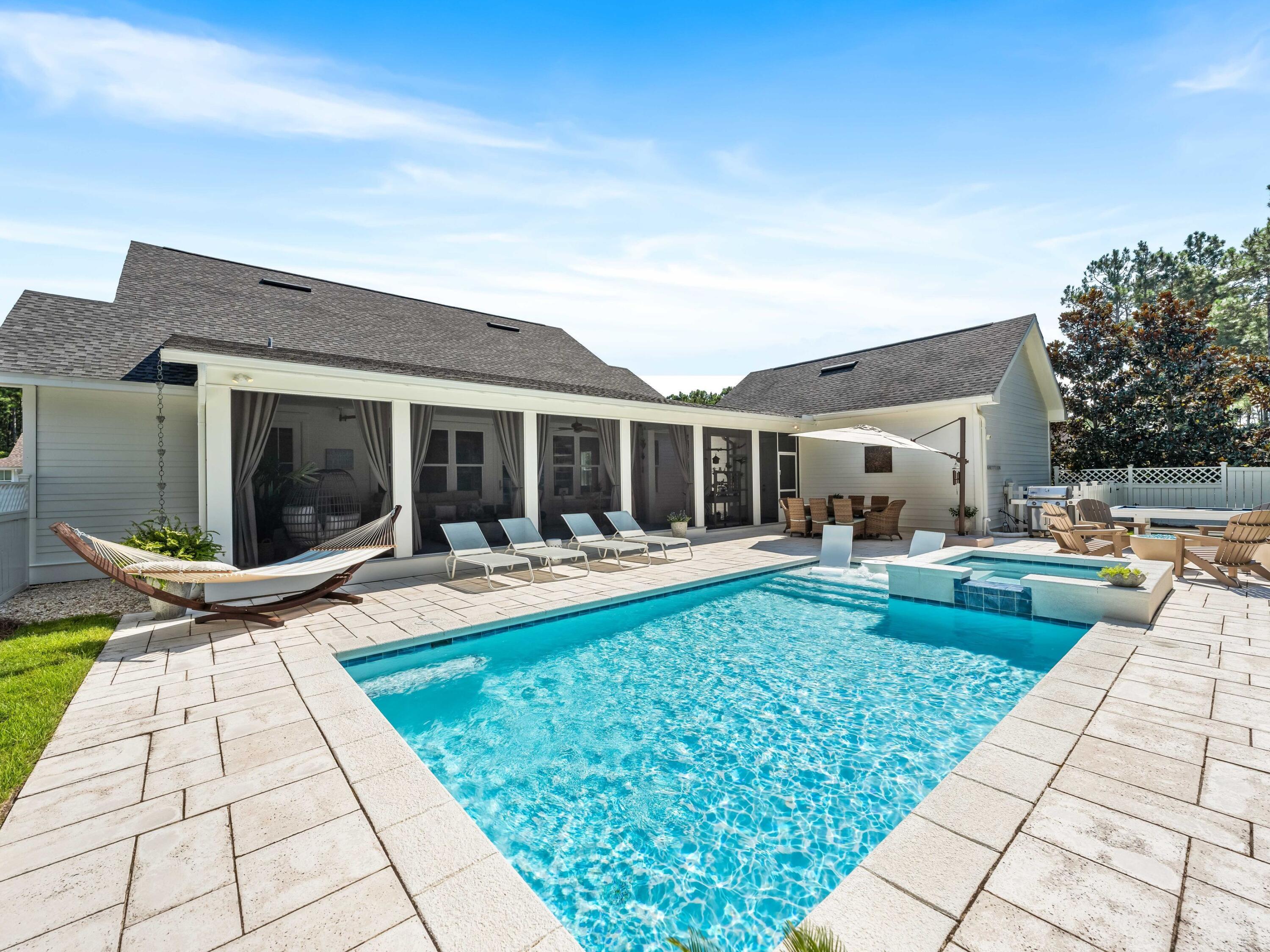 Situated on a spacious corner lot, this charming residence features a private heated pool, spa, fire pit and bocce court providing an idyllic backyard retreat. The immaculate homes sits on an oversized lot and boasts excellent curb appeal and enhanced landscaping. The front walkway leads to a welcoming front porch, inviting guests to relax and unwind.The interior exudes a light and airy ambiance in the open living room, dining and kitchen areas. Shiplap walls, built-in bookcases, medallion wood flooring, ten-foot ceilings, and a beverage/wine refrigerator contribute to the home's unique charm. The kitchen includes a Wolf six-burner stove plus oven and large marble island which is the ideal spot for breakfast gatherings. The spacious screened porch with sizable sitting and dining areas overlooks the backyard oasis. The six foot fence ensures privacy to enjoy all of the outside activities and is surrounded by mature trees. The paver patio offers plenty of room for loungers and chairs for relaxing. Additionally, a mosquito control system and new exterior lighting have been installed throughout.
The elegant master suite offers a tranquil retreat with access to the screened porch, walk-in closet and ensuite with makeup vanity. Three additional bedrooms, two full bathrooms and a powder bath complete this one-level residence.
Numerous high-tech features throughout the house include a Ring doorbell system, home security, and Sonos which extends throughout the home and onto the back porch. For enhanced peace of mind, the residence is equipped with a Generac whole-house generator and upgraded new large-capacity Samsung washer and dryer units. The two-car garage connects through the screened porch and provides ample space for storing beach toys, bicycles, and sports equipment.
Situated within the Watersound Origins community, this picturesque property benefits from a range of shared amenities, including a resort-style pool, walking trails, and tennis courts. The vicinity boasts an abundance of 30A shops, restaurants, live entertainment venues, and pristine beaches, all within a short distance of Rosemary, Alys, and Inlet Beaches.