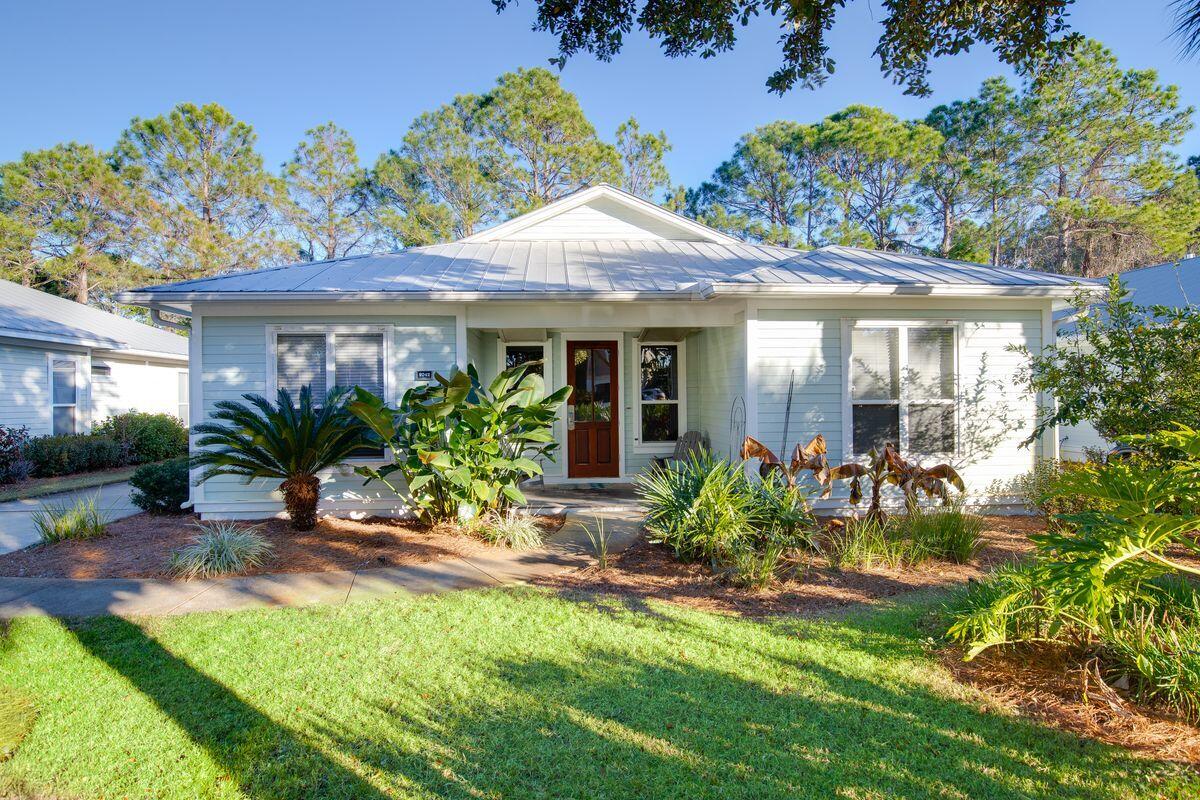 Set in lush surroundings, this single-story Florida cottage has a surprisingly spacious open floor plan for relaxing and entertaining. Cool travertine tile flooring and pastel decor create a light and airy living space that encourages a gentler pace of life. The kitchen is the true hub of this home with a full range of stainless appliances and a granite-topped island. It's the natural place for families to socialize over breakfast pancakes or tasty nibbles and cocktails before dinner. The adjoining dining area with an exquisite chandelier easily seats eight guests for family meals and celebrations. The master bedroom exceeds expectations boasting an ensuite bathroom with an oversized shower, walk-in closet and a seating area for watching late-night TV. It also has direct access to the