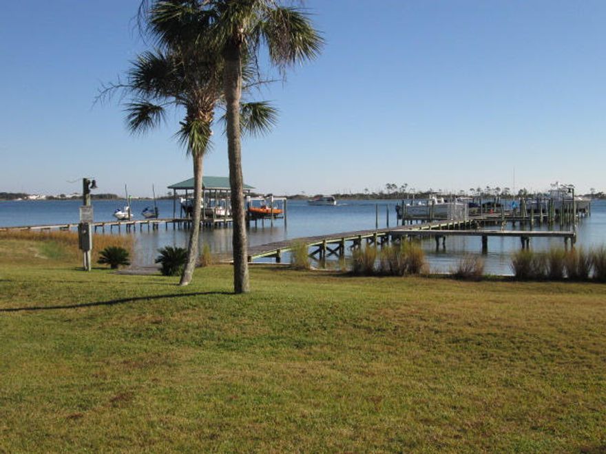 VA Compromise Sale..Upgrades galore in this beautiful townhome with a DEEDED BOAT SLIP, COMMUNITY POOL AND TENNIS COURT! Within 2 miles to Hurlburt..no more sitting in traffic for hours when you can be home enjoying yourself. This end unit, with lots of natural light, is immaculate and the owners have taken such pride in upgrading with some of these notable features: TRANE 19 Seer...yes, 19, A/C unit and Handler with digital display, new water heater and dishwasher, smooth ceilings throughout, engineered hardwood flooring upstairs and tile downstairs, all three bathrooms are completely remodeled with many special features, recessed lighting with dimmer switches, new deck off of master bedroom, granite hop up breakfast bar. Complex includes lawn maintenance, pool, community room,