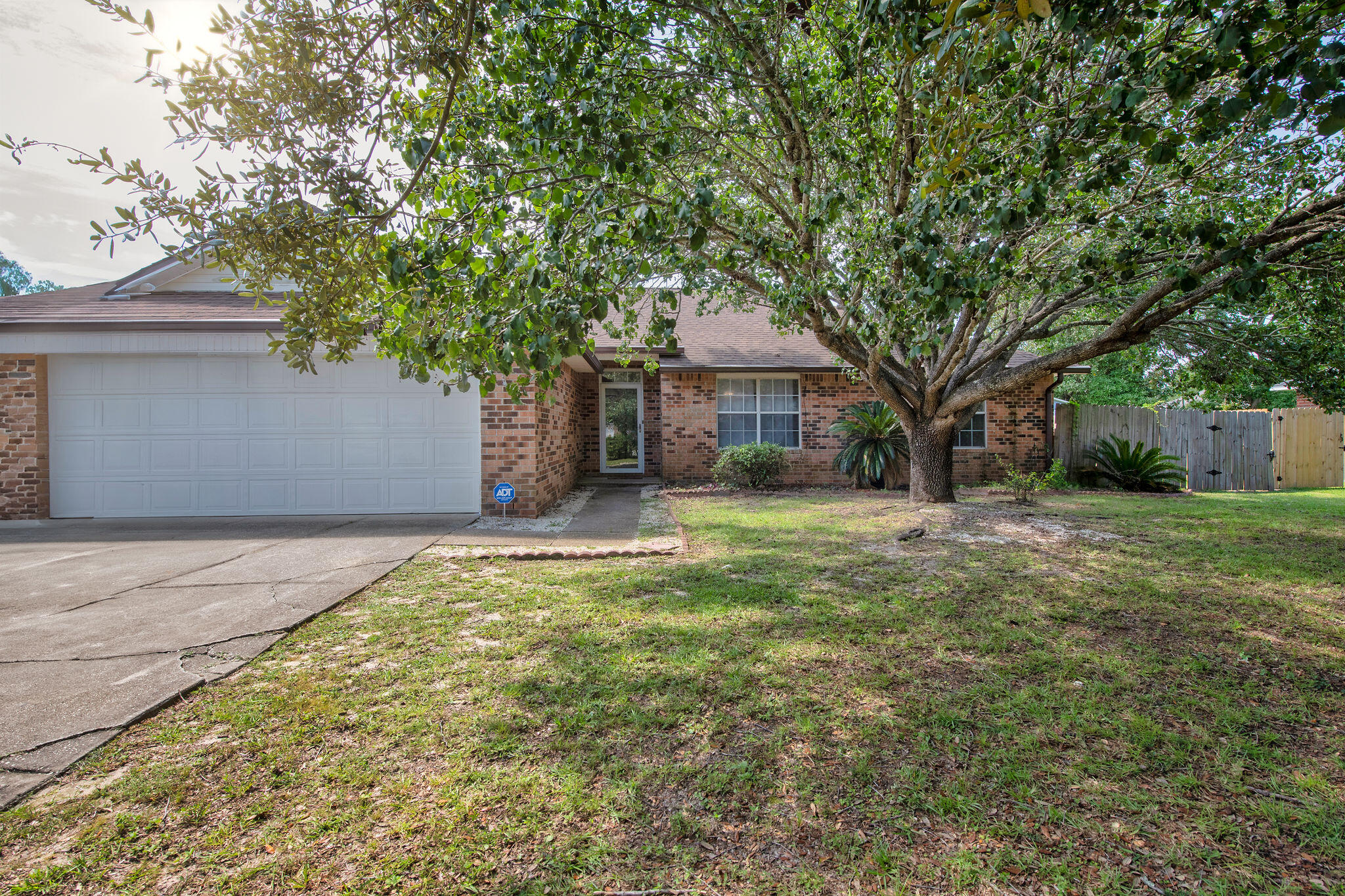 ALL BRICK NO HOA NO CARPET!Tucked away on a peaceful cul-de-sac, this 3-bedroom, 2-bath home showcases a desirable split floor plan with vaulted ceilings and open, sunlit living spaces. Stylish bamboo and tile flooring flow throughout, complemented by modern lighting and a welcoming fireplace. Step outside to a private fenced yard with a 30-amp RV hookup, perfect for extra flexibility. The finished 2-car garage features epoxy floors, attic storage, and a built-in workbench. Major updates include a 2019 roof, plus HVAC and water heater replaced in 2017. Conveniently close to schools, shopping, dining, military bases, and just minutes from beautiful Navarre Beach.